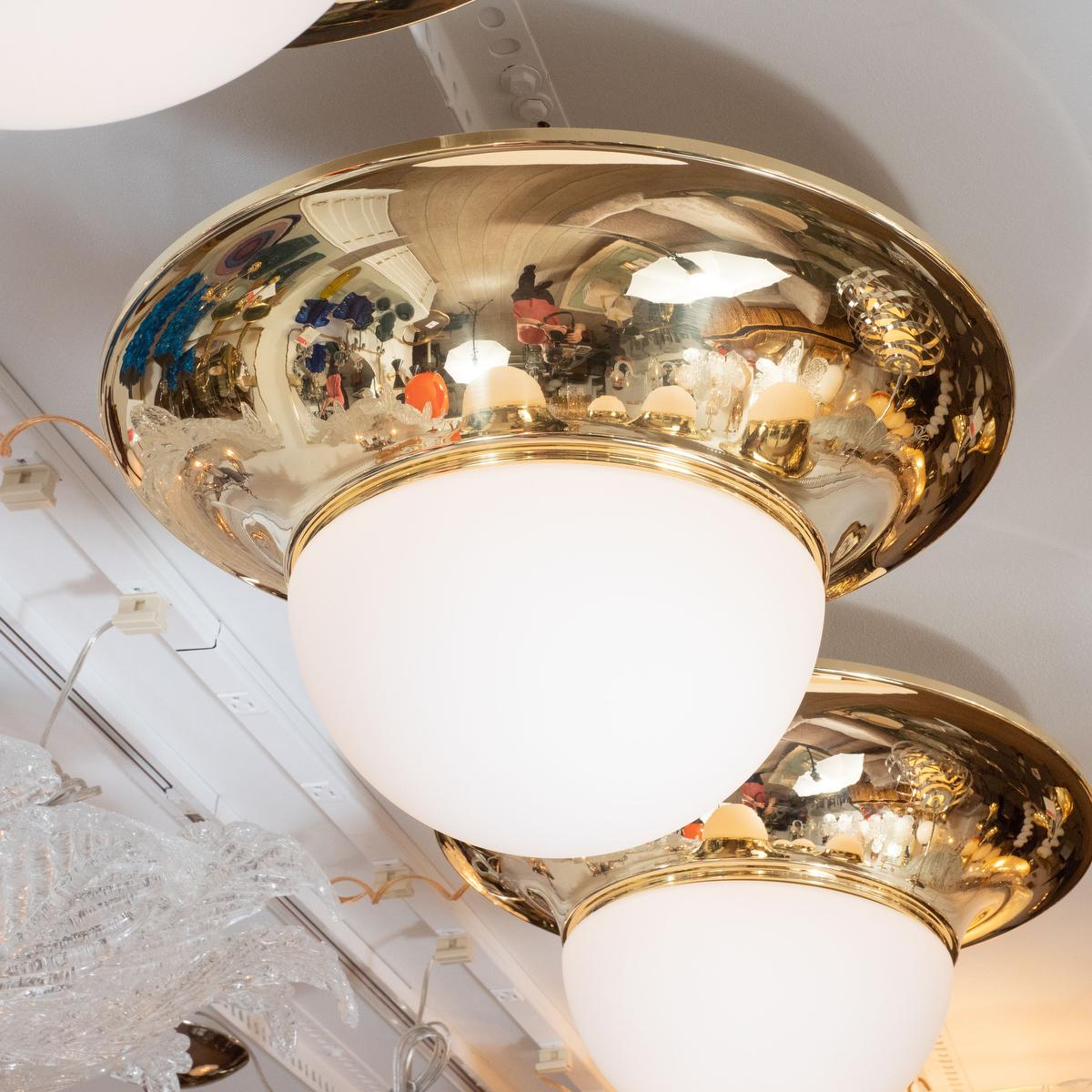 Brass modernist flushmount ceiling fixture with white frosted globe by Luigi Caccia Dominioni.