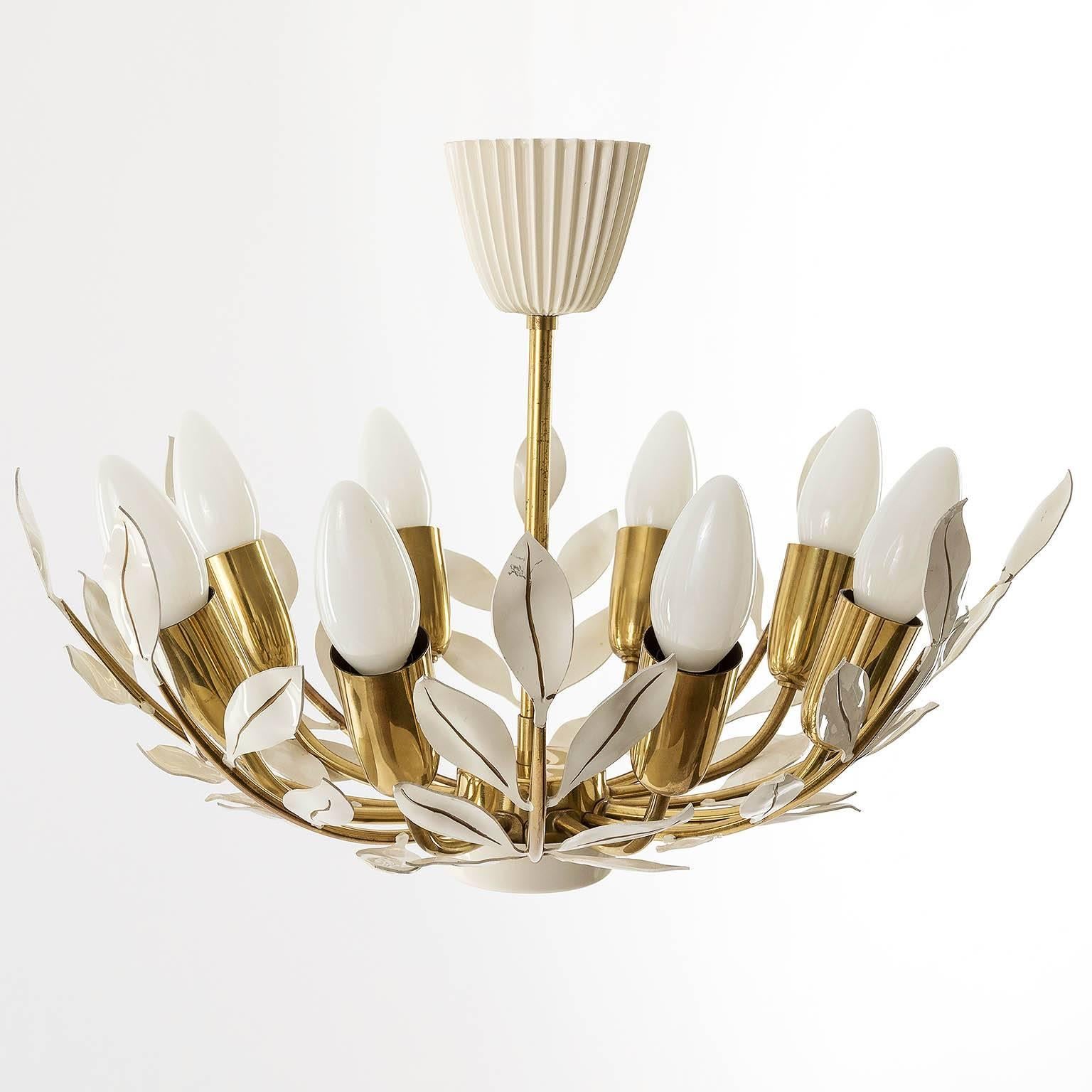 A beautiful floral light fixture by Vereinigte Werkstätten München, Germany, manufactured in midcentury, circa 1960 (late 1950s or early 1960s).
A polished brass frame white enameled leaves and eight sockets for small screw base bulbs E14.
It is