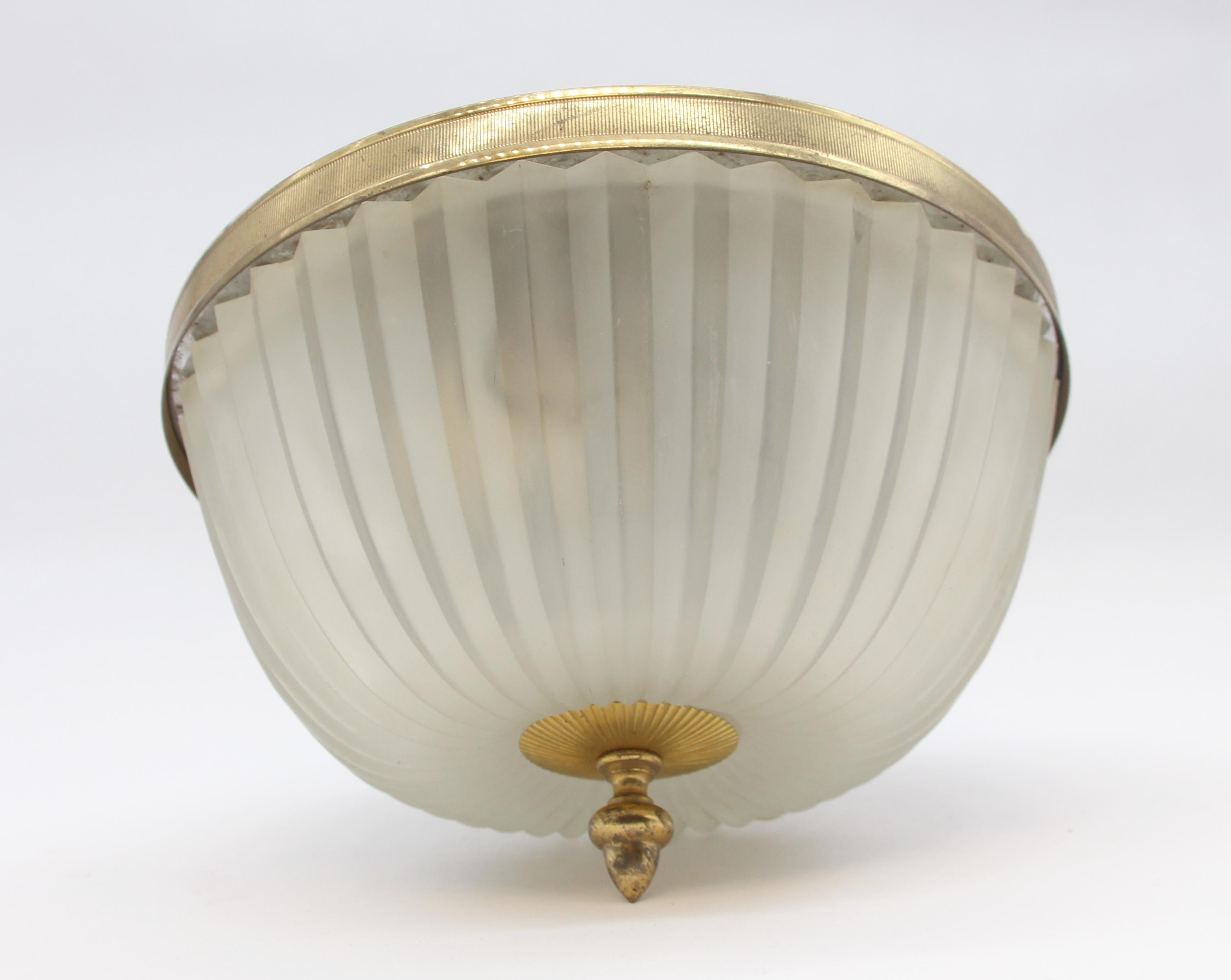 1960s brass flush mount light fixture with a heavy cast frosted prism style glass shade. Accented with a matching brass bottom final. Features three standard E26 sockets. Small quantity available at time of posting. Please inquire. Priced each.