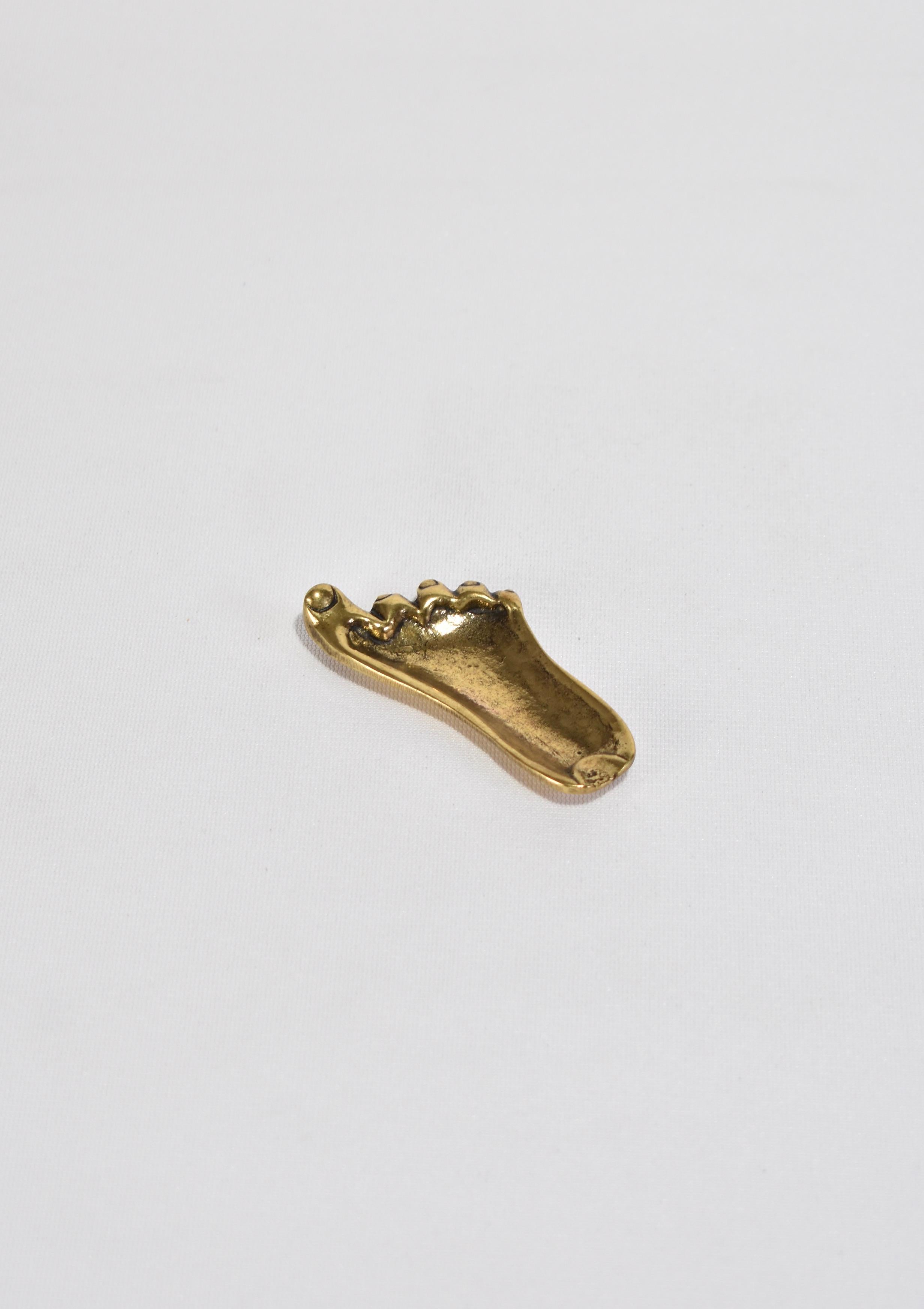 Miniature brass foot object. Perfect size to hold a ring or display on its own as a sculptural piece.