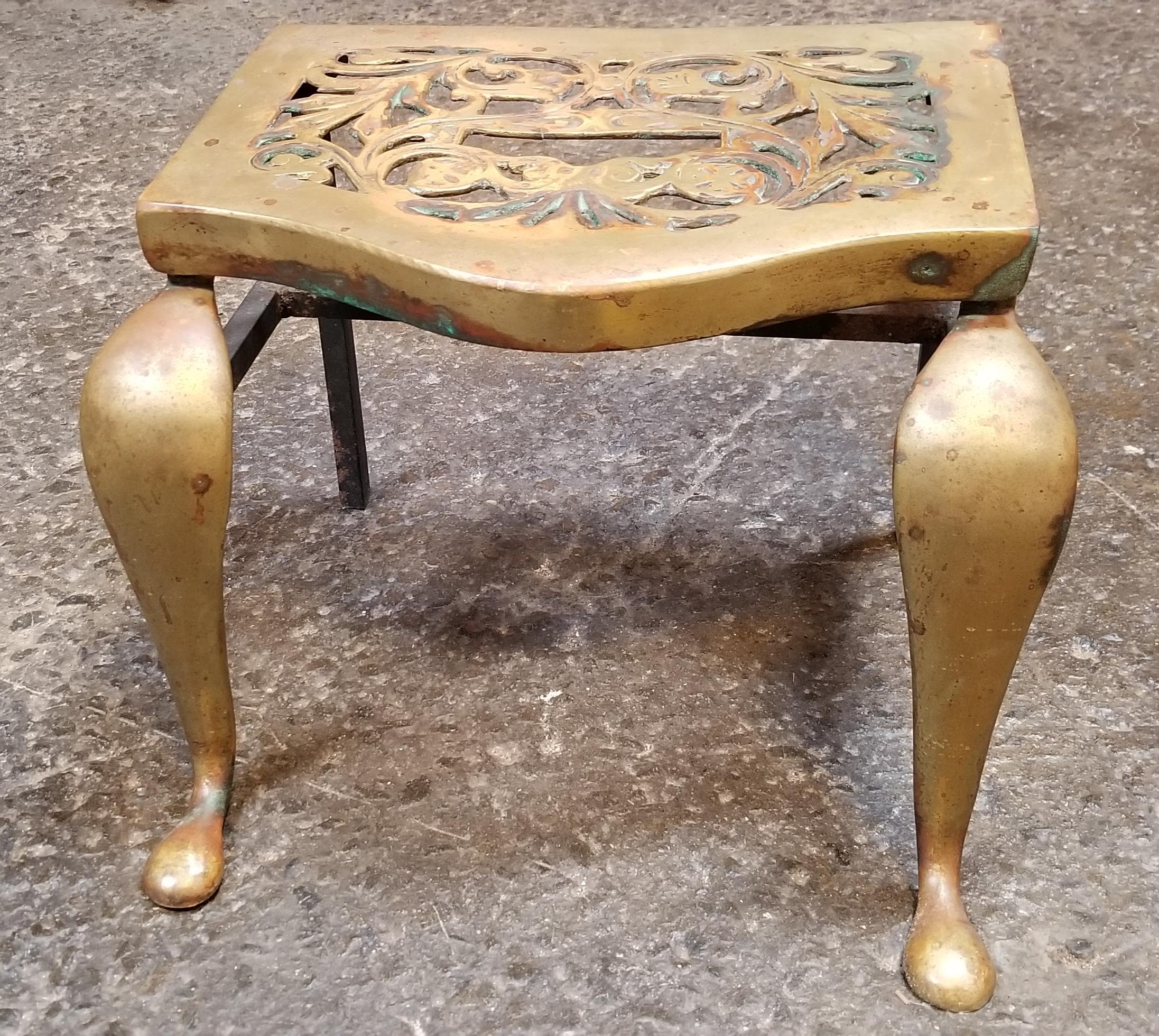 A 19th century brass footman stool with a leaf pattern design. Made of solid cast brass attached to iron base. Could also be used as a side or end table or plant stand.