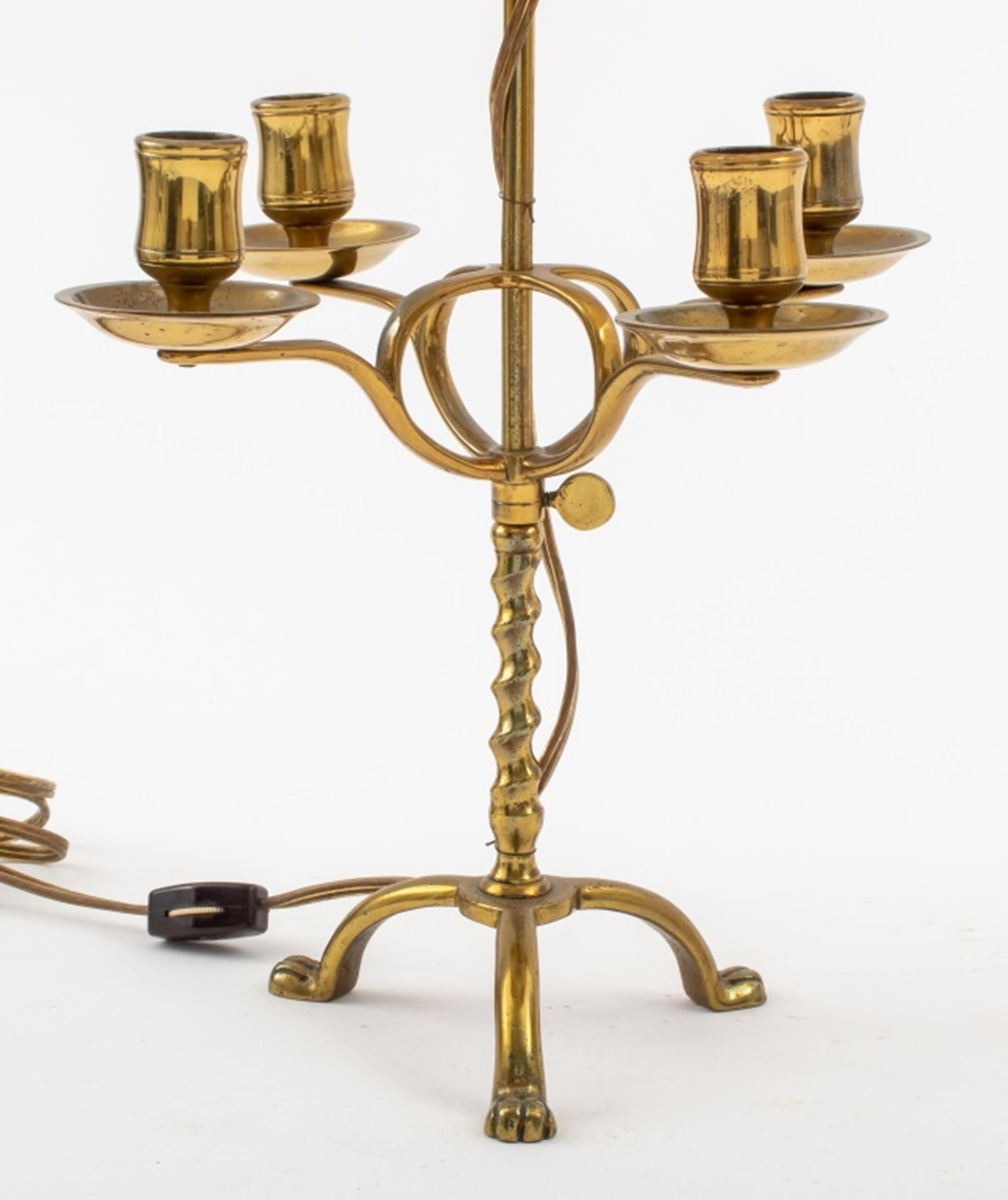 Pair of brass lamps, with four arms for candles, later addition of two sockets for light bulbs, unmarked. 
Dimensions: 21.5
