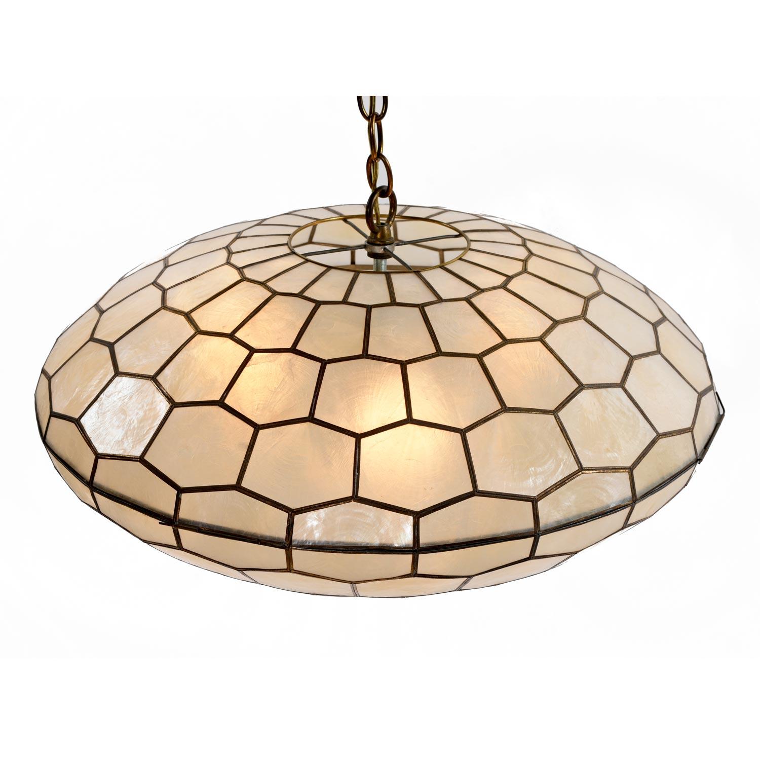Vintage saucer shaped capiz shell pendant light. The dramatic pendant light fixture mounts to the ceiling and hangs on a 15' long chain with cord. The luxurious lamp is made from thin sheets of capiz shell that act as natural light diffusers. The