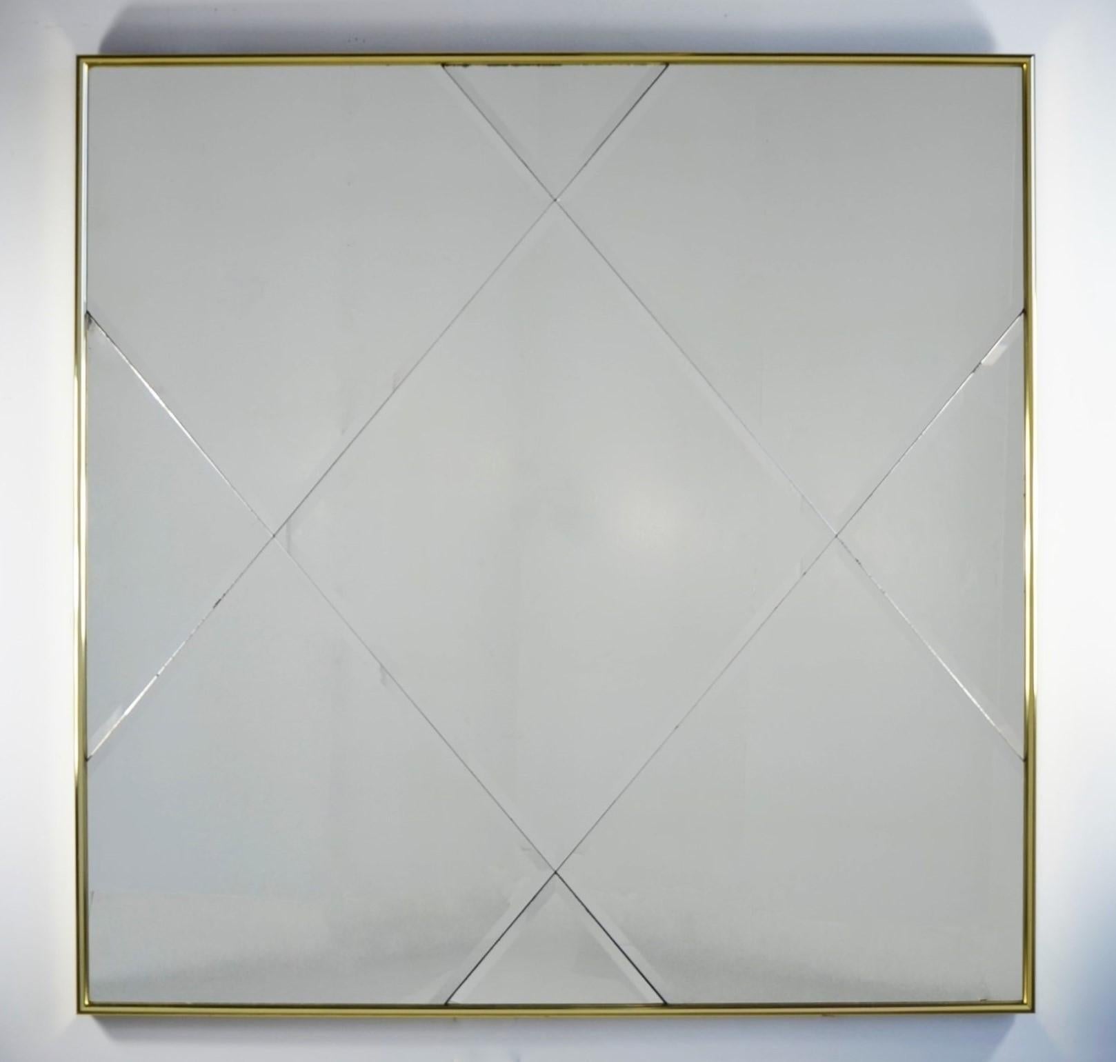 Offered is a Mid-Century Modern brass frame and harlequin pattern beveled glass wall mirror. This beautiful brass harlequin pattern beveled glass wall mirror is an exquisite example Mid-Century Modern decorative wall art. This mirror, with its high