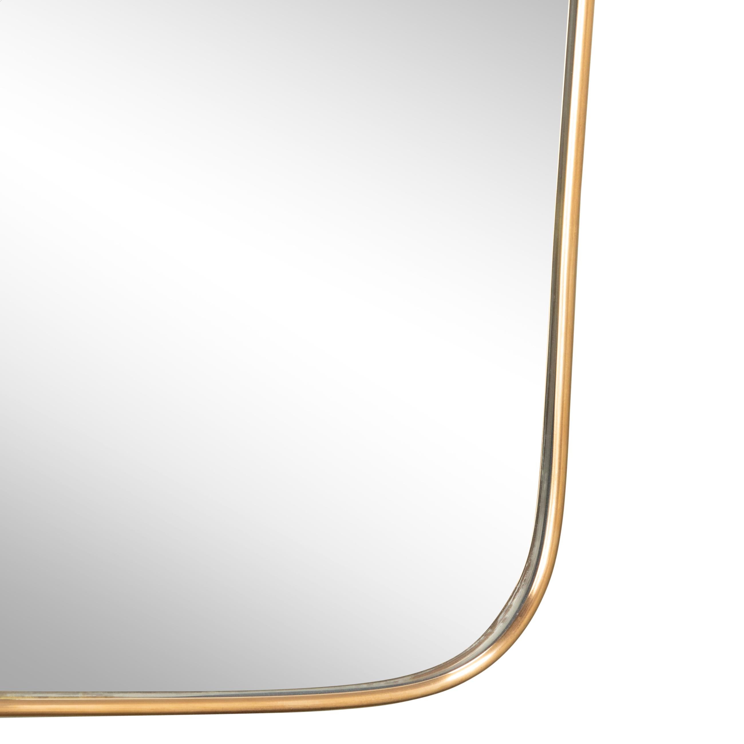 Brass Framed mirror in the style of Gio Ponti
Curved edges.
Italy, circa 1950. 

Dimensions, Measures: 

Hauteur / Height : 90 cm / 35.4 inch 
Largeur en haut / Width at the top : 60 cm / 23.6 inch 
Largeur en bas / Width at the bottom :53.5