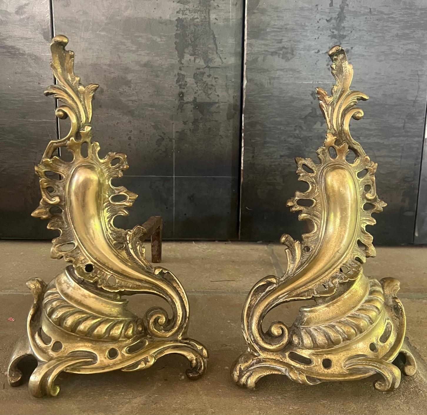 Antique brass andirons made in France in the early part of the 20th century.