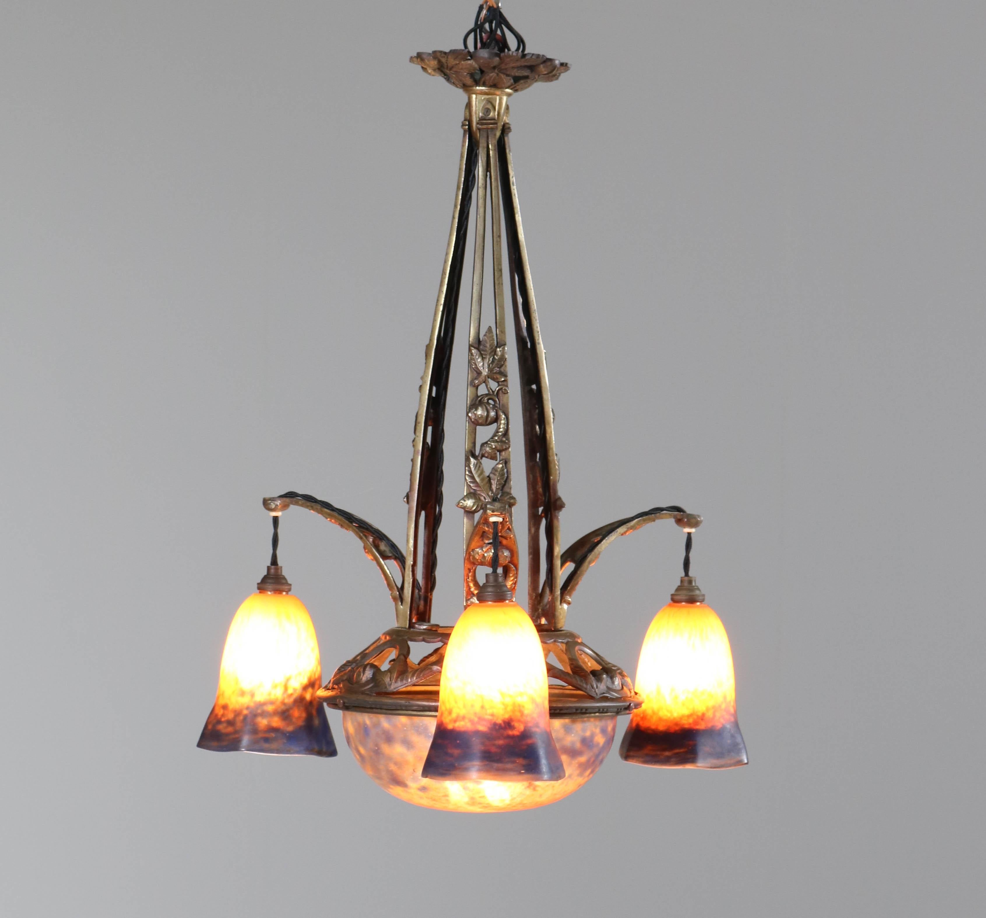Stunning Art Deco chandelier.
In the style of Muller Freres Luneville.
Striking French design from the thirties.
Original brass frame with original pate de verre glass shades.
Rewired and in very good condition with a beautiful patina.
 
