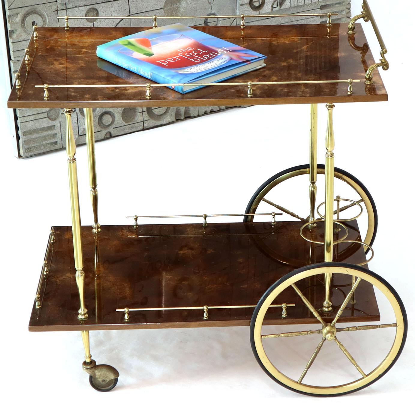 Mid-Century Modern lacquered parchment bar cart by Aldo Tura. Large six turned brass spokes wheels.