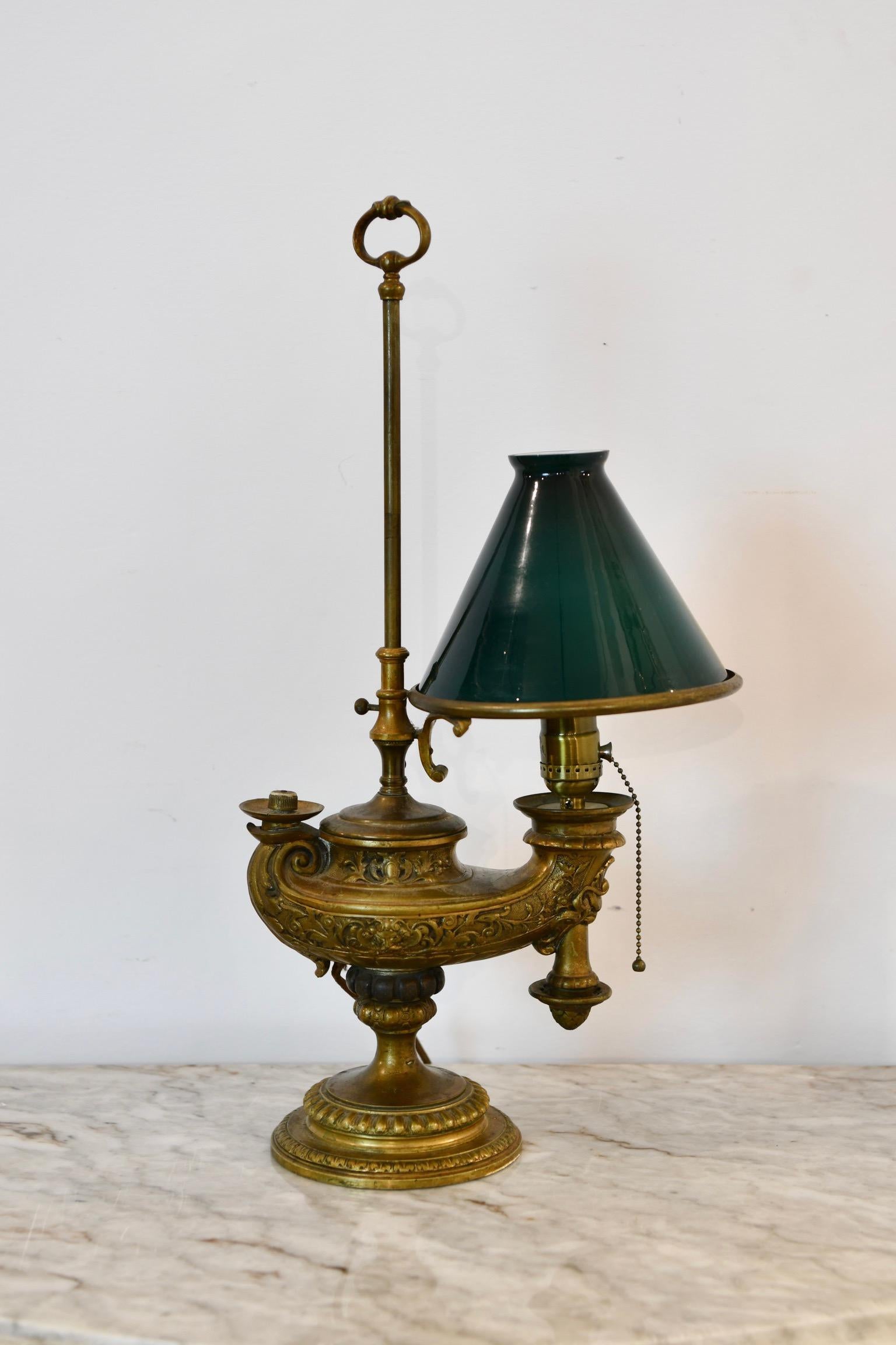 Brass genie electrified student lamp with green cased glass shade. Dimensions: 21.5