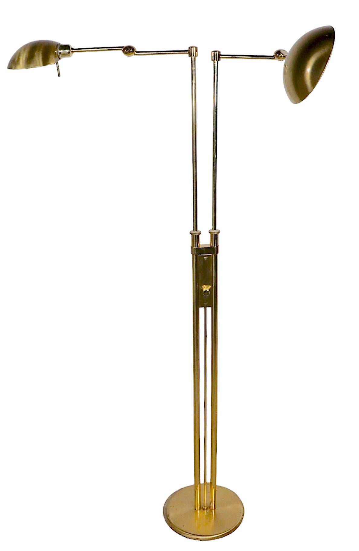 Chic two arm floor lamp by noted German maker, Holtkoetter, circa 2000-2010. The lamp is adjustable in H ( 40 - 57 inch ) the swing arms each have two approximately 9 inch segments, allowing extension to approximately 18 inch each. The hood shades
