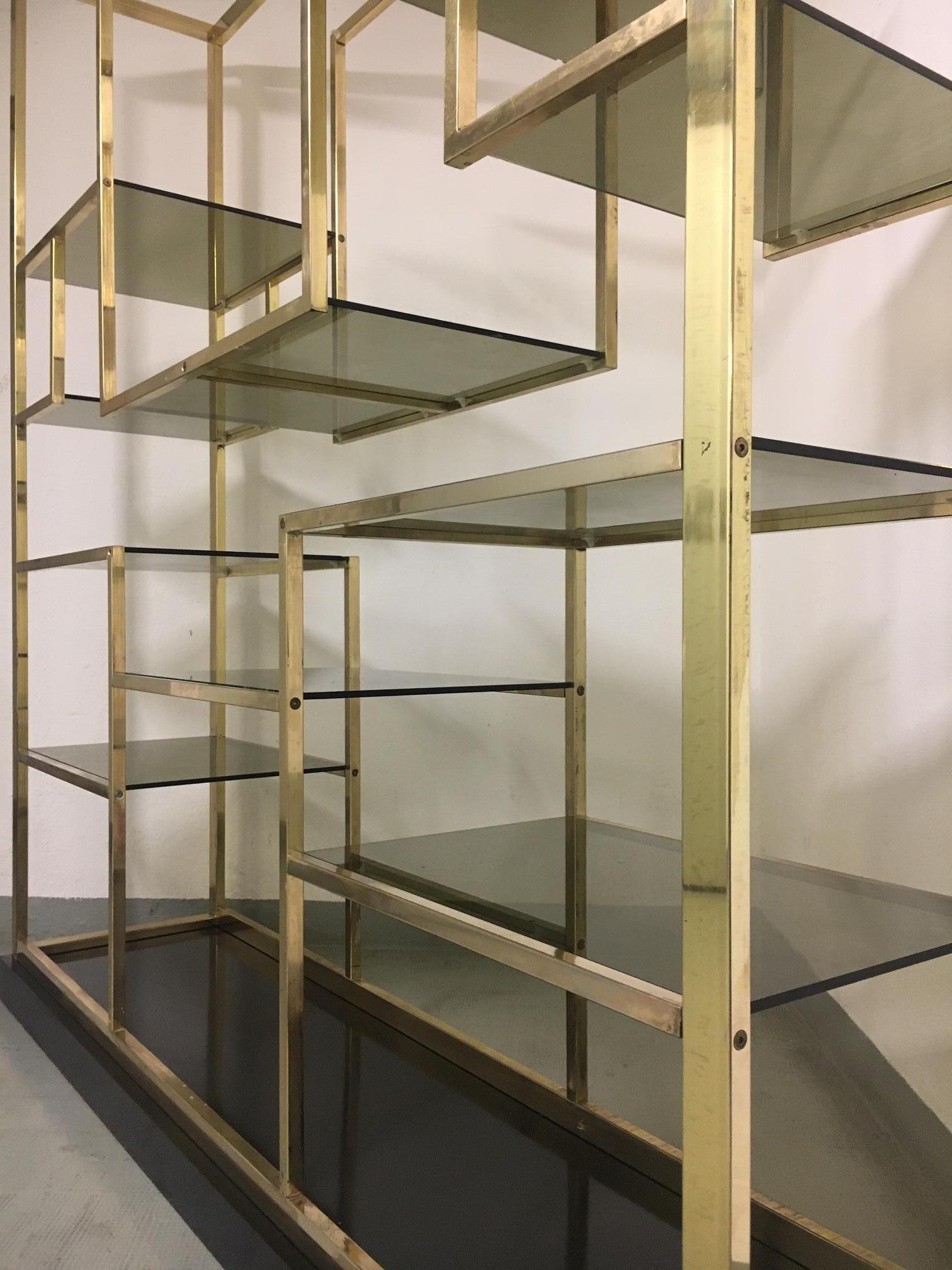 brass and glass shelving unit