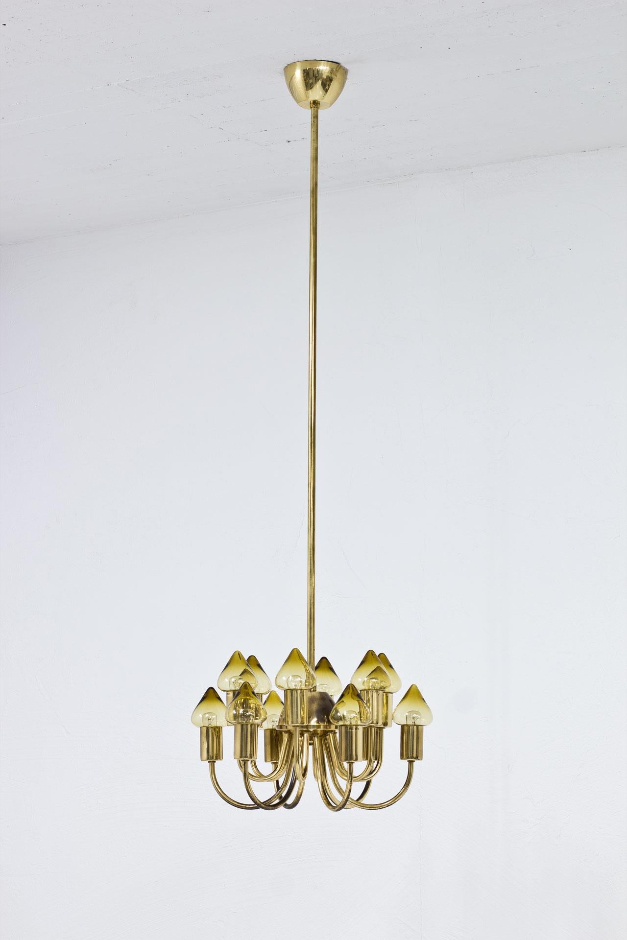 Rare ceiling lamp model T 789/12 designed and manufactured by Hans- Agne Jakobsson in Sweden during the 1950s. Made from brass with twelve original light yellow glass shades. The height of the brass stem on demand is adjustable on demand.

The