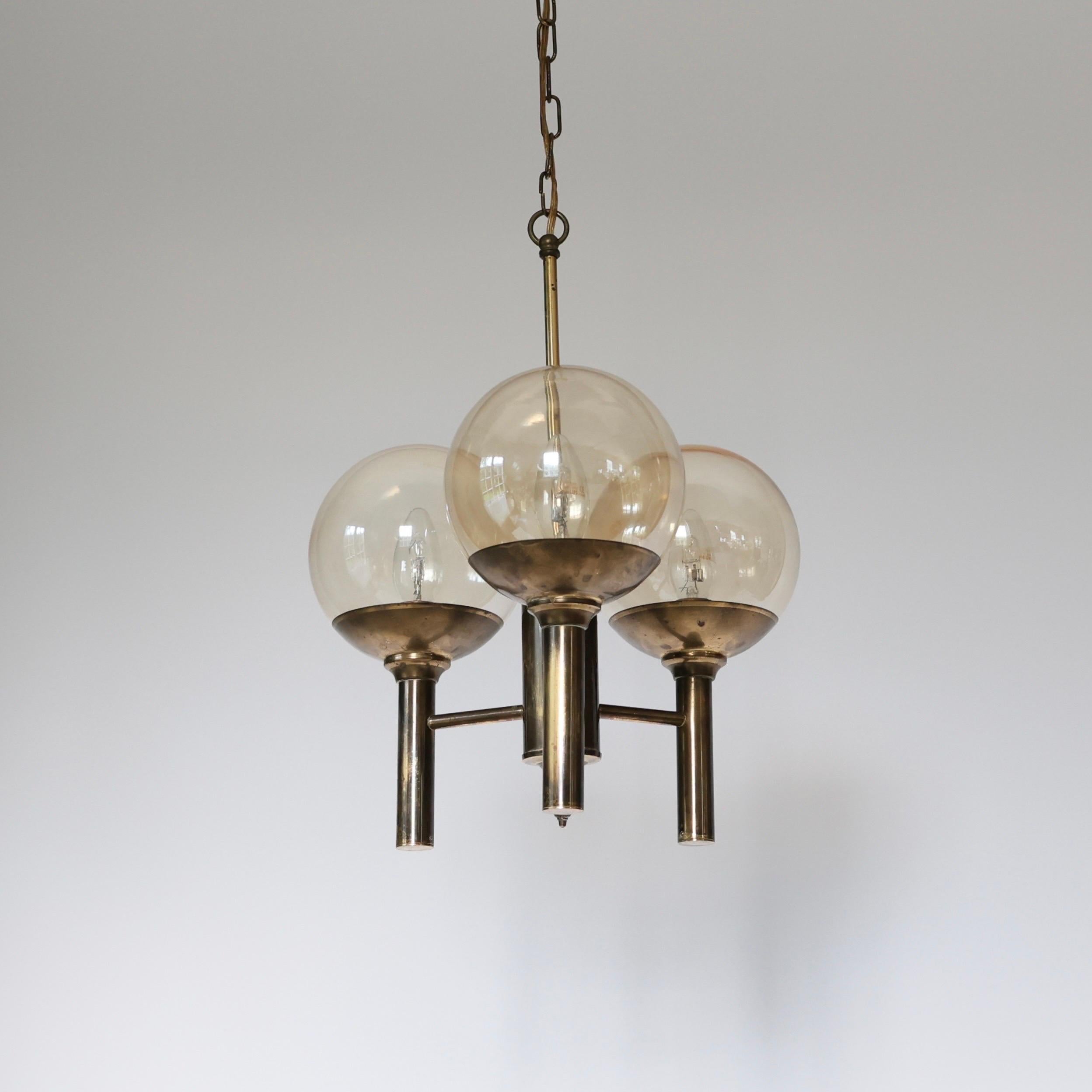 Brass Chandelier with Smoke-Colored Glass Shades made by Svend Mejlstrøm in the 1960s. 

* Brass pendant light with three round smoke-colored glass shades
* Designer: Svend Mejlstrøm
* Manufacturer: Mejlstrøm Belysning
* Year: 1960s
* Condition: