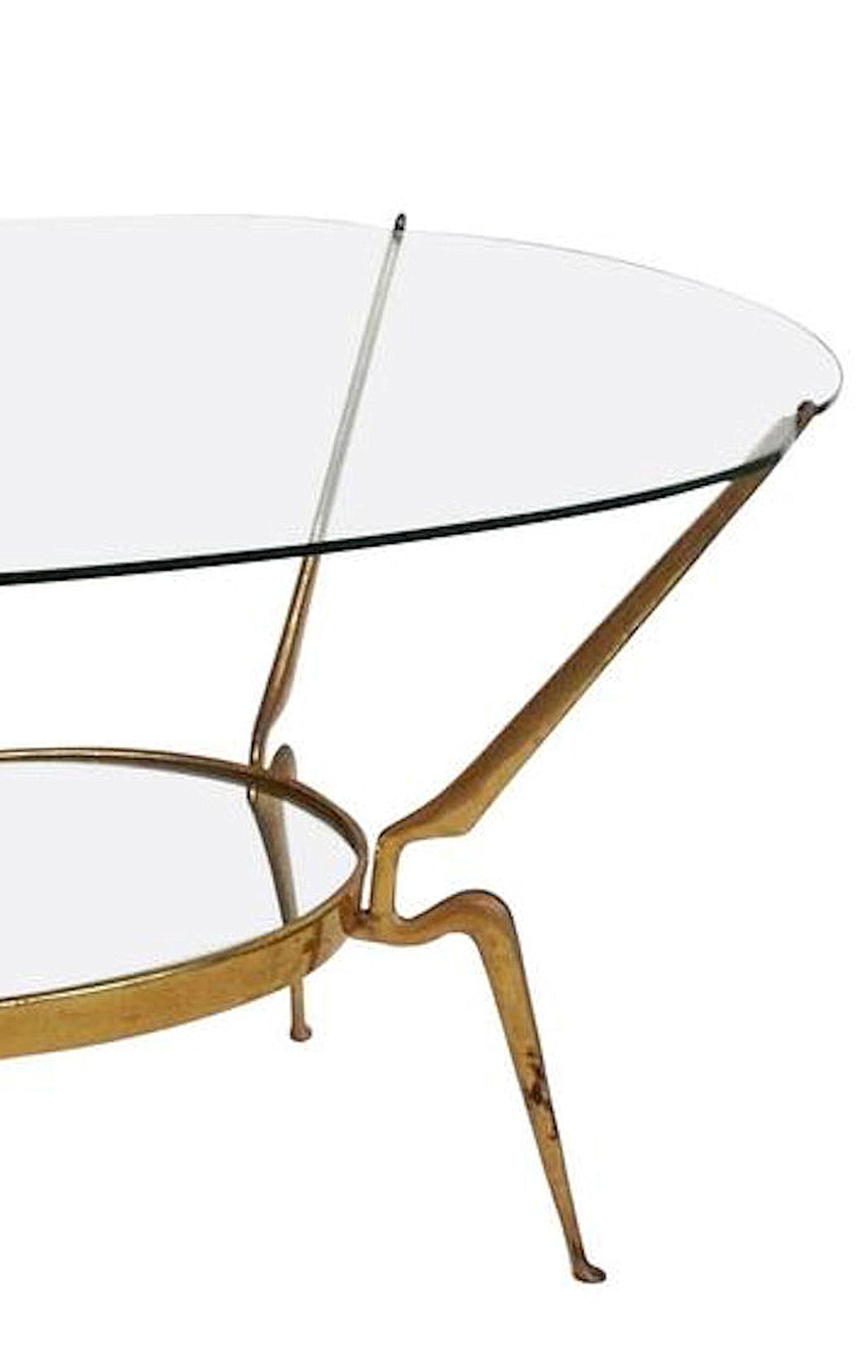 Brass and clear glass top coffee or side table, by Cesare Lacca, Italy, 1950s.
Oval shape clear glass top, curved brass legs, and clear mirror bottom shelf.
The brass legs have some patina, normal, with age, but no alterations.
Everything is