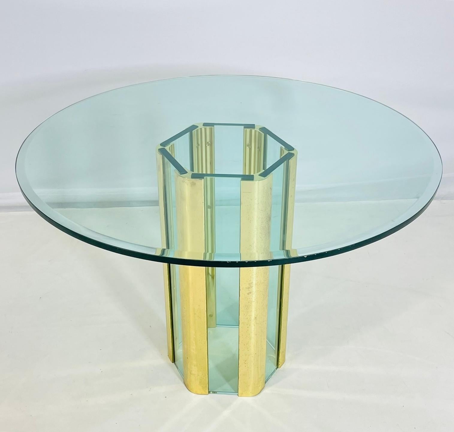 A stunning modernist dining or center table designed by Leon Rosen for Pace Collection, circa 1970s–1980s. The sculptural hexagonal base is composed of alternating panels of polished brass and thick beveled glass, creating a dynamic interplay of