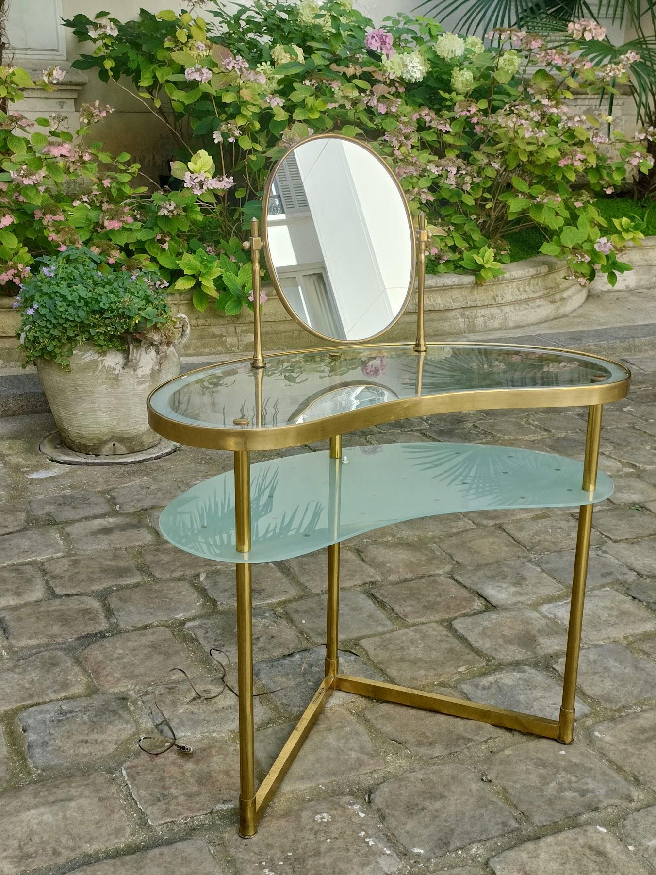 Unique and exceptional piece
.
Brass and glass dressing table, with mirror, lighting and steering wheel, by Luigi Brusotti.
.
Italy, 1940s.
.
So poetic...
.
Width : 92cm at the widest
Height : 76cm
Depth : 43cm

Mirror height : 40cm
Mirror width :