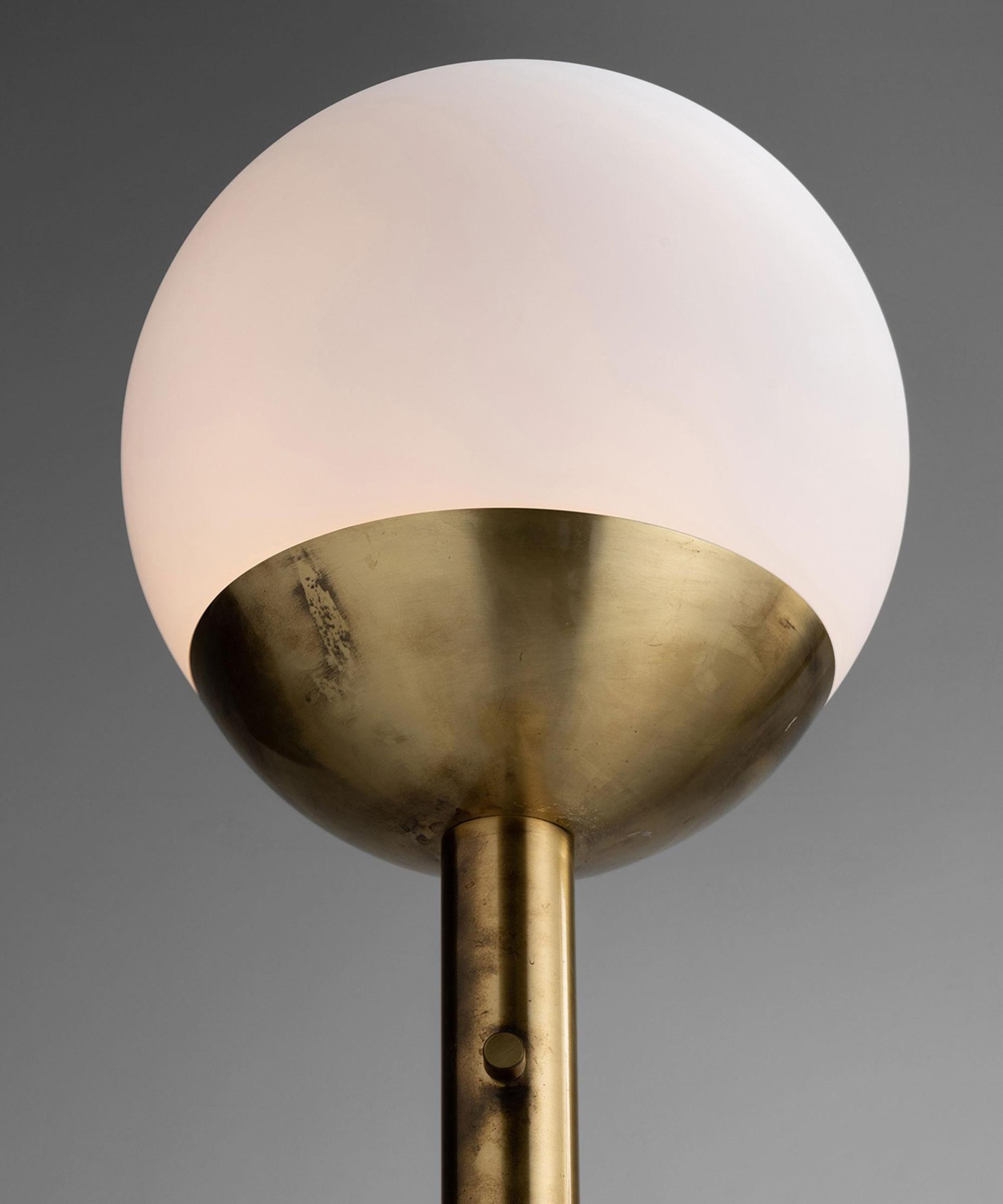 Tall brass lamp with large frosted glass globe.


Measures: 19