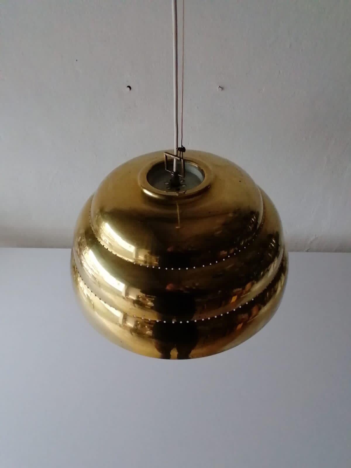 Gorgeous brass & glass suspension pendant lamp style of Paavo Tynell 1960s Finland

Unusual and rare design. 

Lampshade is in good condition and very clean.

This lamp works with E27 light bulb. Max 100W
Wired and suitable to use with 220V