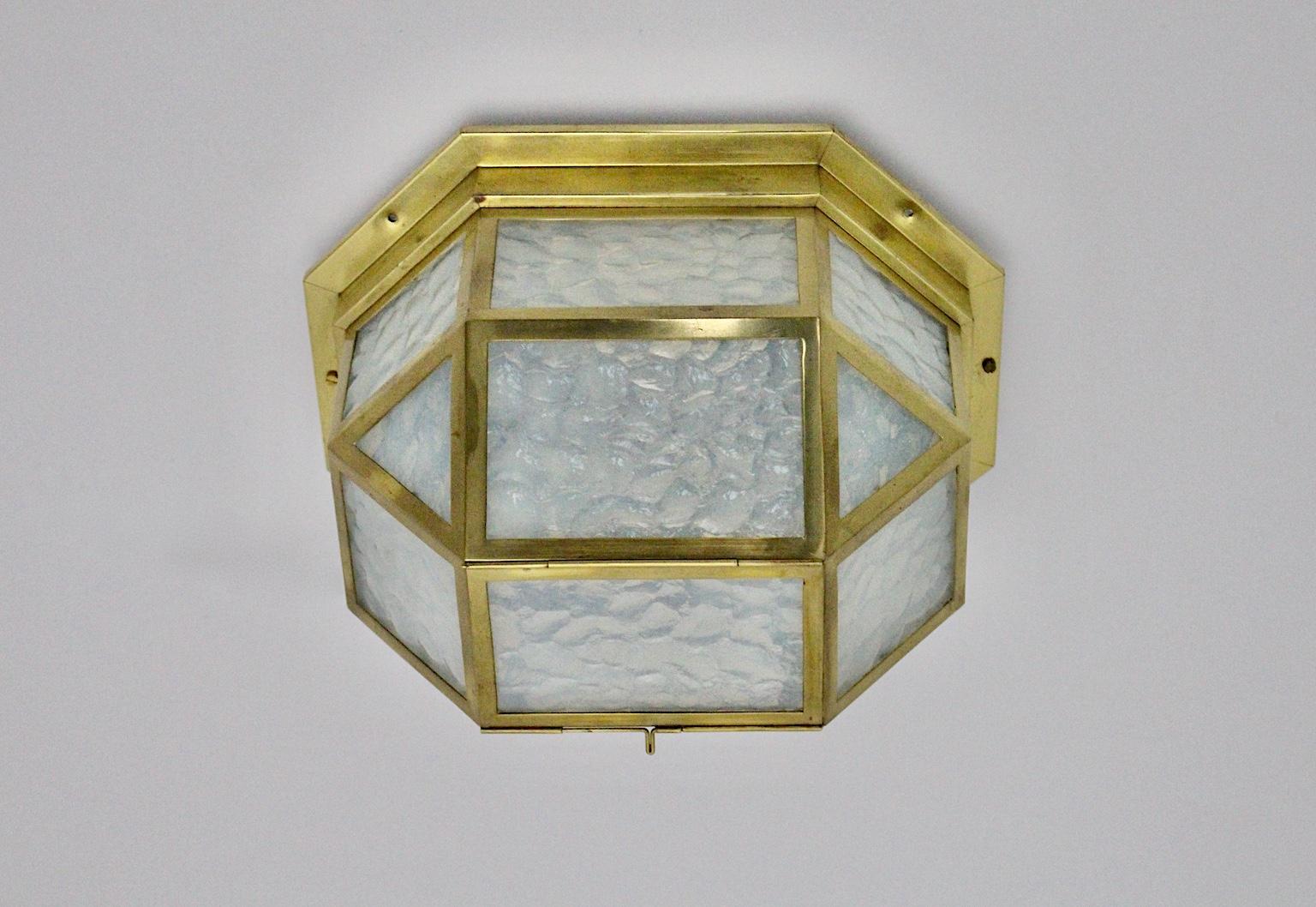 A brass vintage Jugendstil flushmount or sconce, which shows light blue structured opaline glass and a brass frame.
The handmade Jugendstil brass flushmount was designed circa 1903 in Vienna in the style of Joseph Hoffmann. The sconce was made out