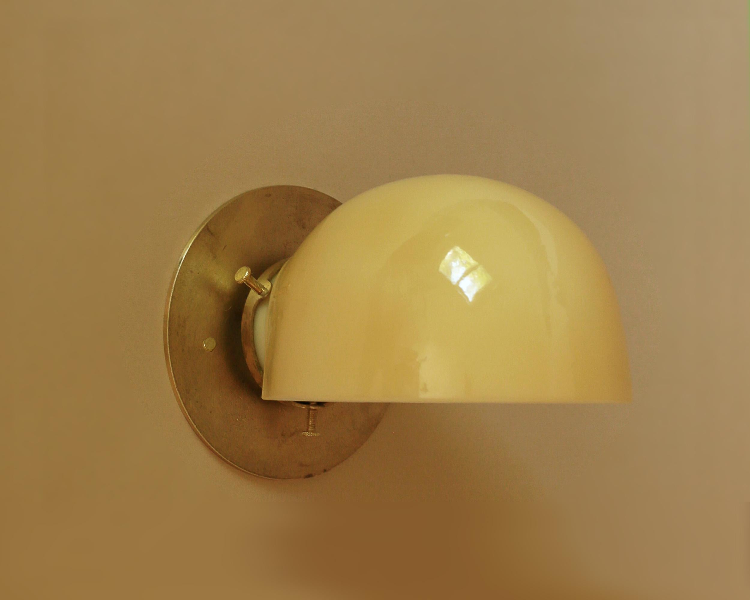 American Brass Glass Wall Light With Buff Color Shade by Artig Lighting For Sale