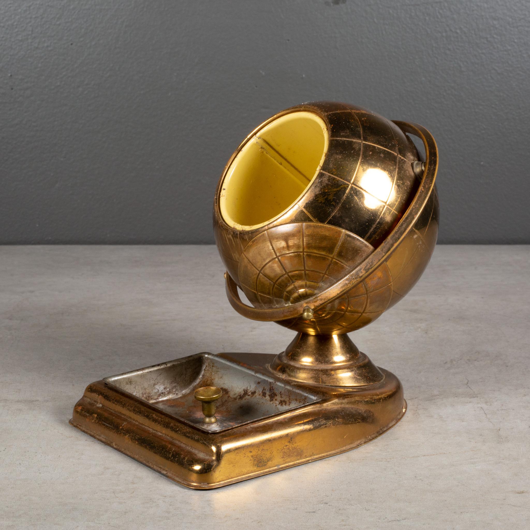 ABOUT

An original mid-century brass cigarette holder with ashtray or coin dish. The lid slides open on the globe's axis to reveal a metal interior designed to hold cigarettes. 

    CREATOR: Unknown.
    DATE OF MANUFACTURE: circa 1960
   