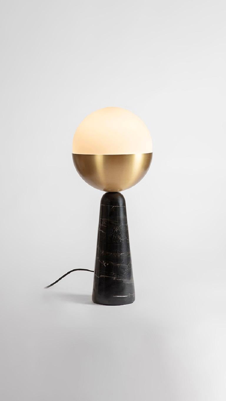 Brass Globe Table Lamp by Square in Circle
Dimensions: H 60 x W 25 x W 13.5
Materials: brushed brass finish, white frosted glass, black marble.

Our minimal table lamp has been crafted to ensure its dominating, unabashed globe becomes the