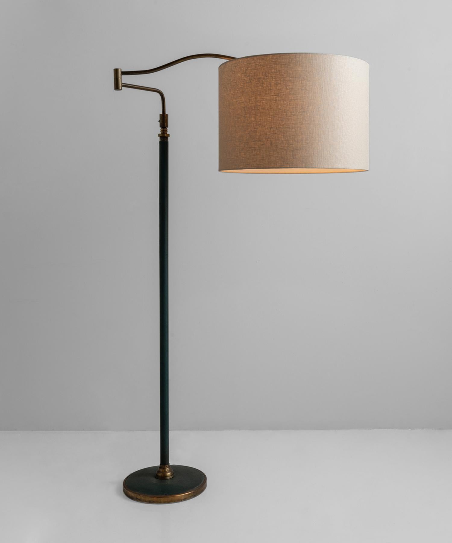 Brass & green leather floor lamp, Italy, 1950.

Leather-wrapped stand includes brass detailing throughout and multiple points of adjustment. New linen shade.