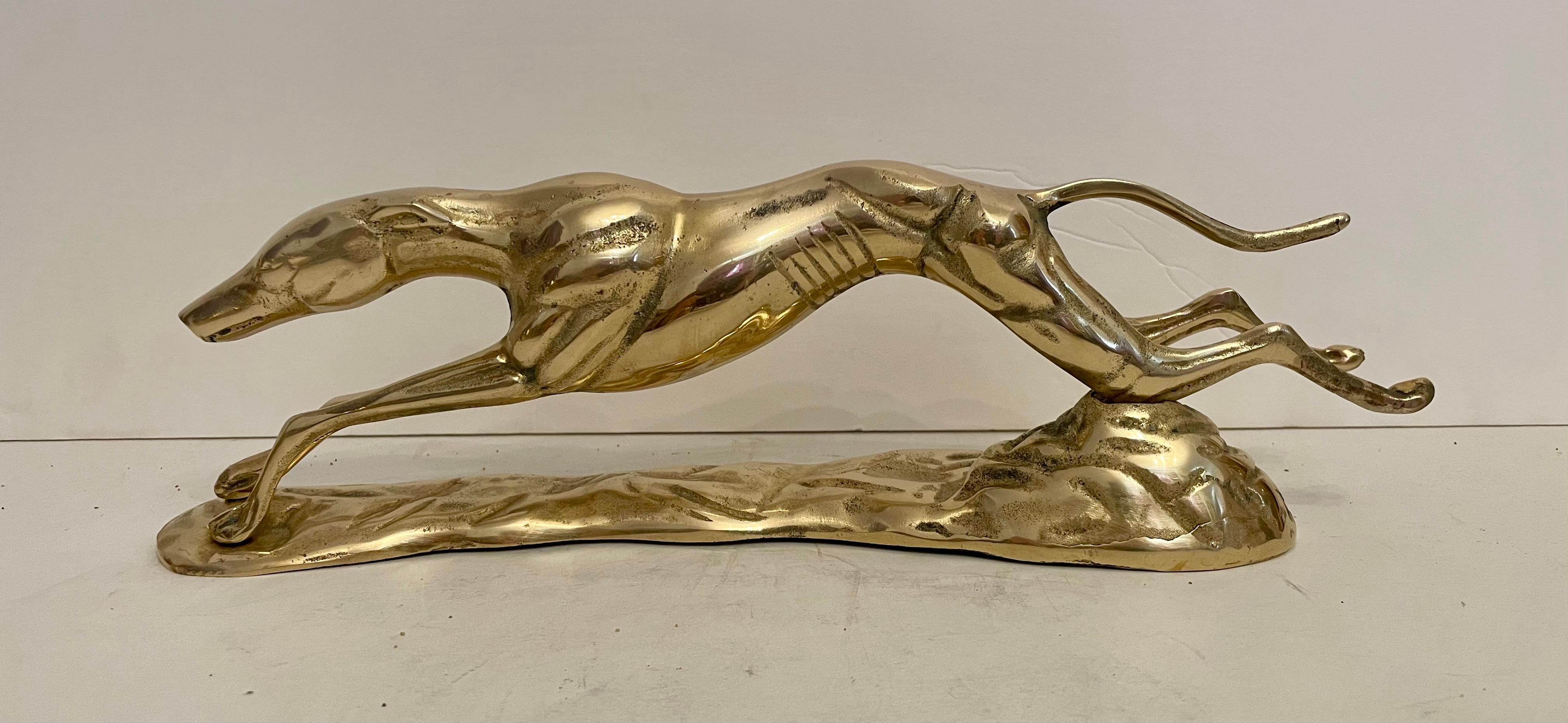 Vintage Hollywood Regency brass Greyhound sculpture. Nicely detailed. Hand polished. Depicts greyhound in full stretch running. Good overall condition. Dark spots are reflection of light in photos.  QUICK SHIP