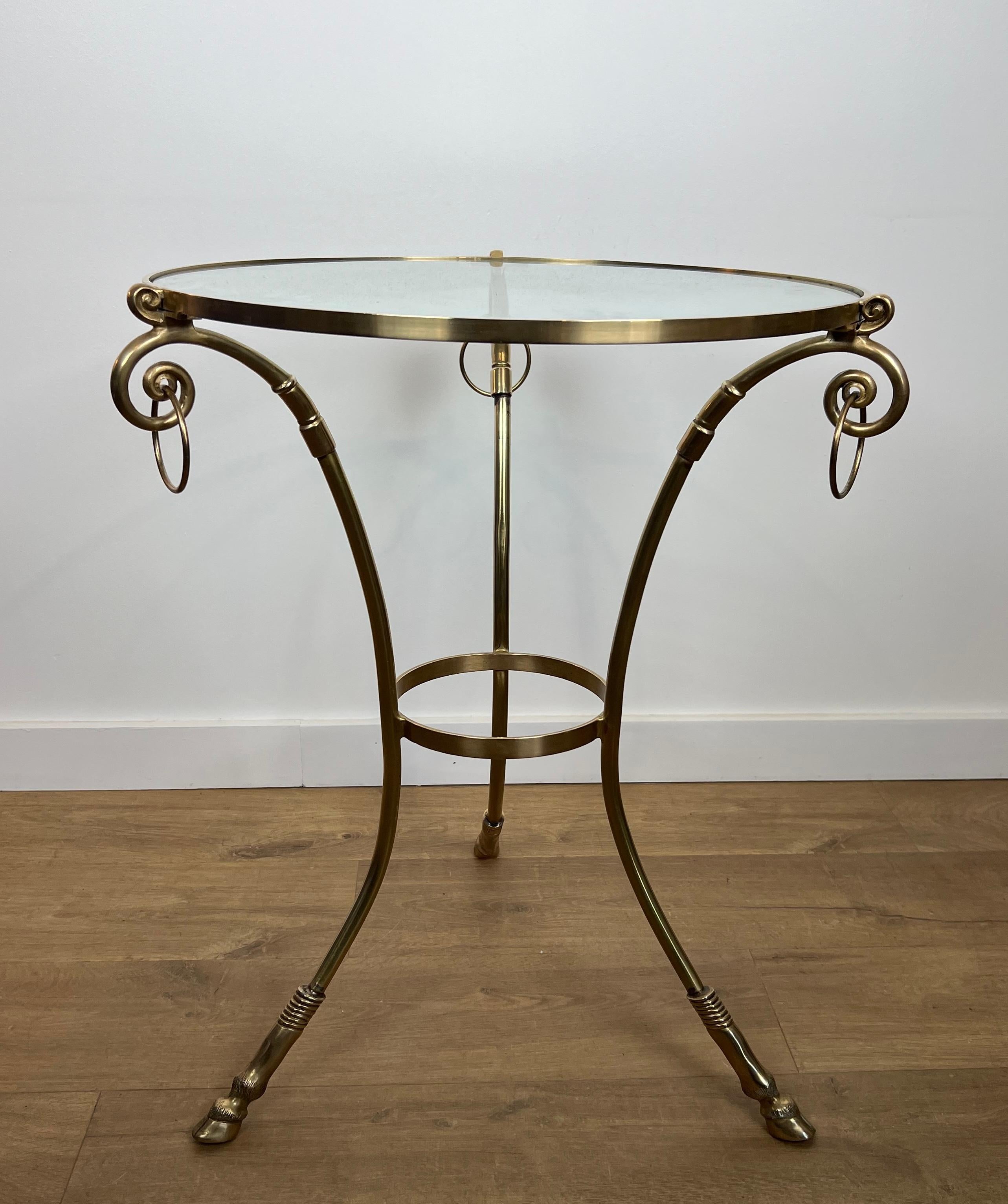 This very nice neoclassical style tripod gueridon is made of brass with round glass shelf on top. This is a French work by Maison Jansen. Circa 1970