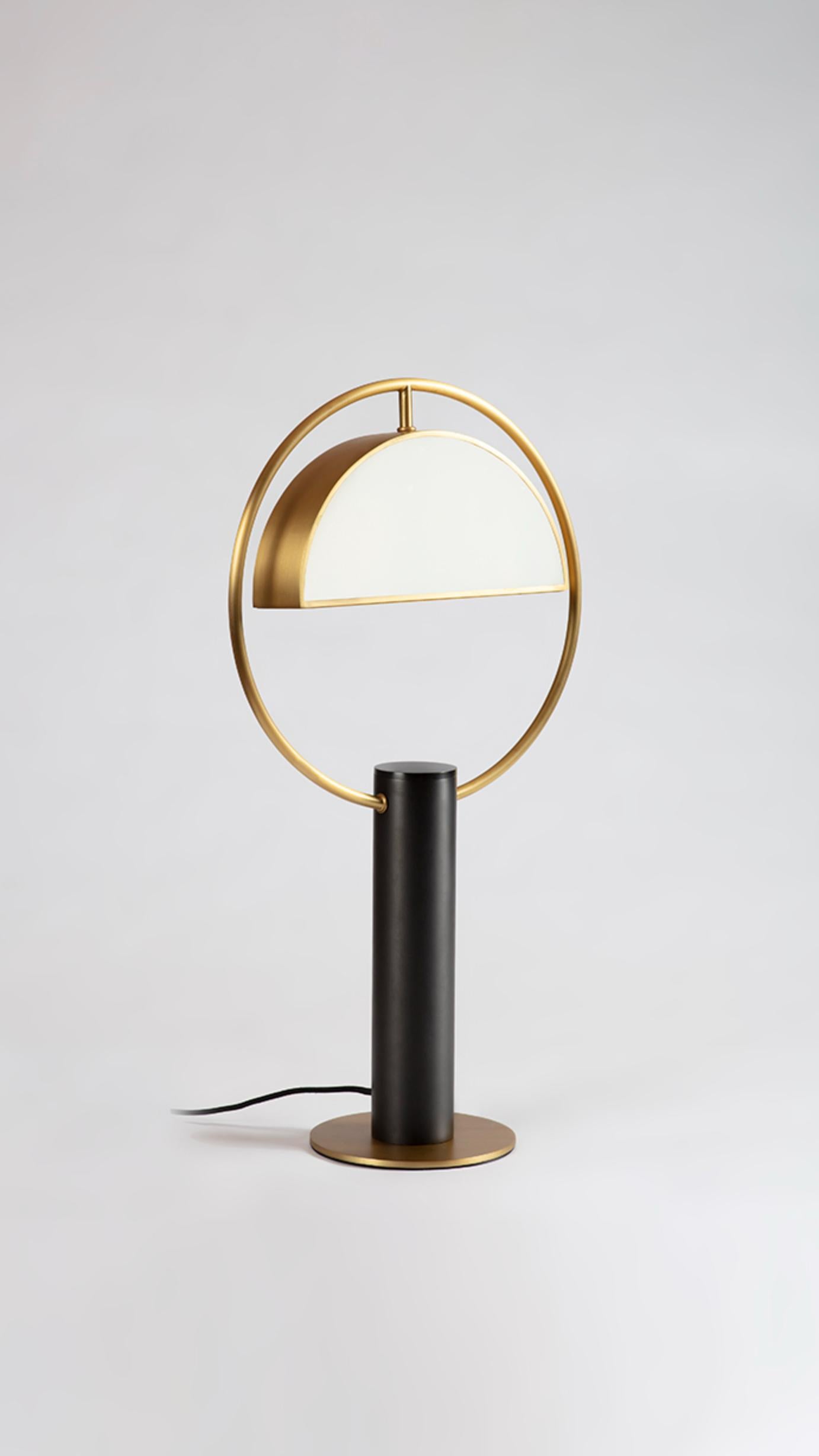 Brass Half in Circle Table Lamp by Square in Circle
Dimensions: H 55 x W 30 x D 5 cm.
Materials: brushed brass finish, white frosted glass, dark grey metal. 

Inspired by costume design from the Triadic Ballet by Oscar Schlemmer, geometric forms are