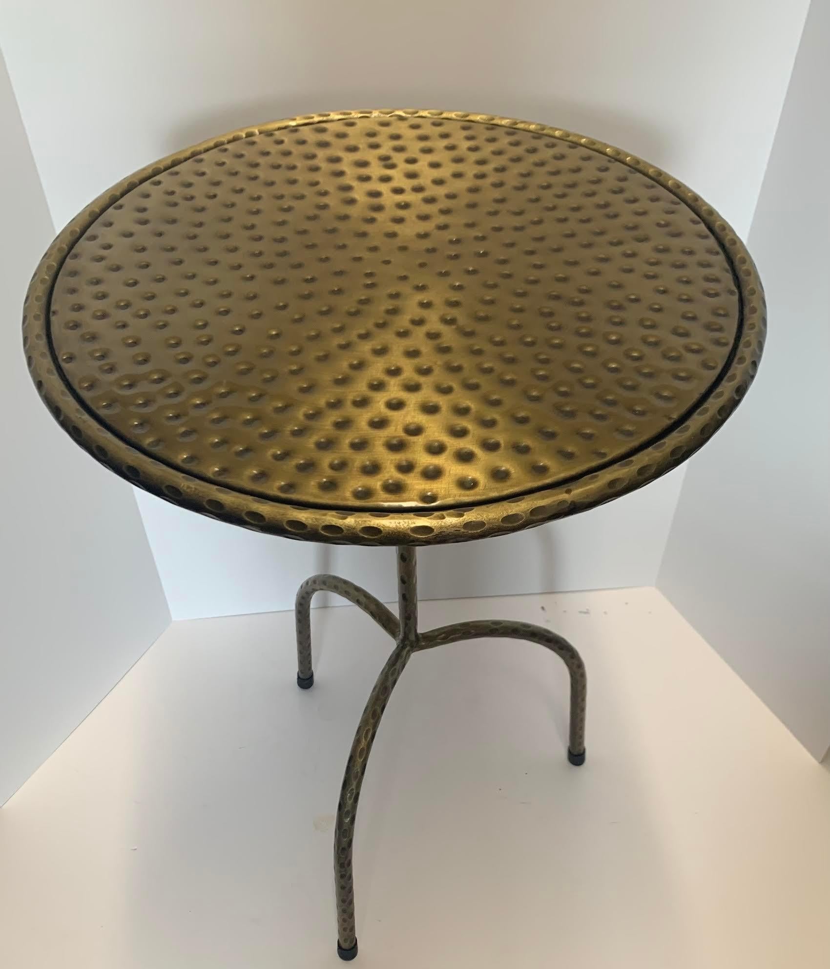 Contemporary Indian hammered brass top cocktail table.
Tripod legs.