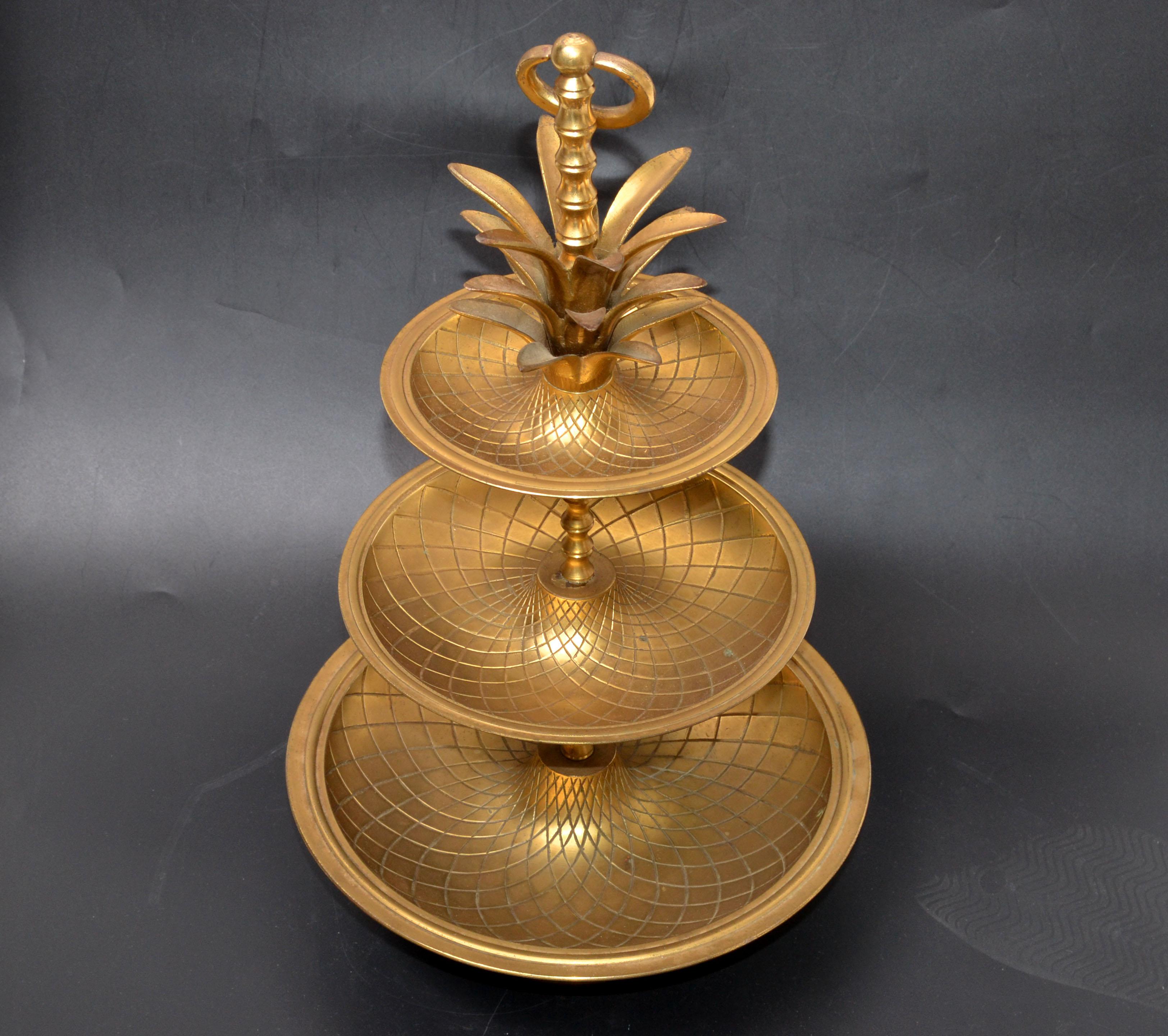 Hollywood Regency brass pineapple 3-tier nesting serving tray stand.
Trays measure from 10.25 inches to 7.75 to 5.75 inches in Diameter.
       