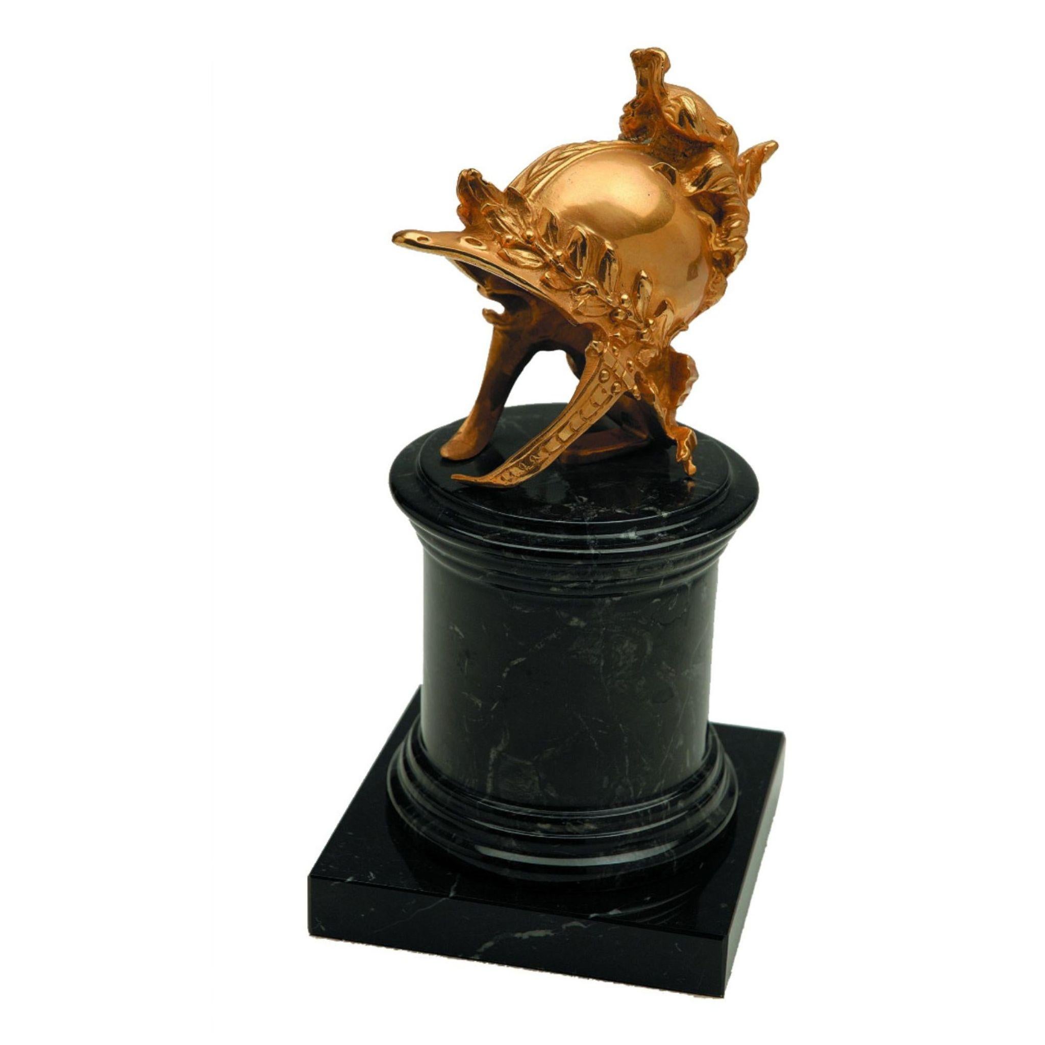 Add a touch of sophistication to any room with this natural brass helm, mounted on a sleek black marble base. The intricate detailing and high-quality construction make it a stunning decorative piece that's perfect for a wide range of decor styles.