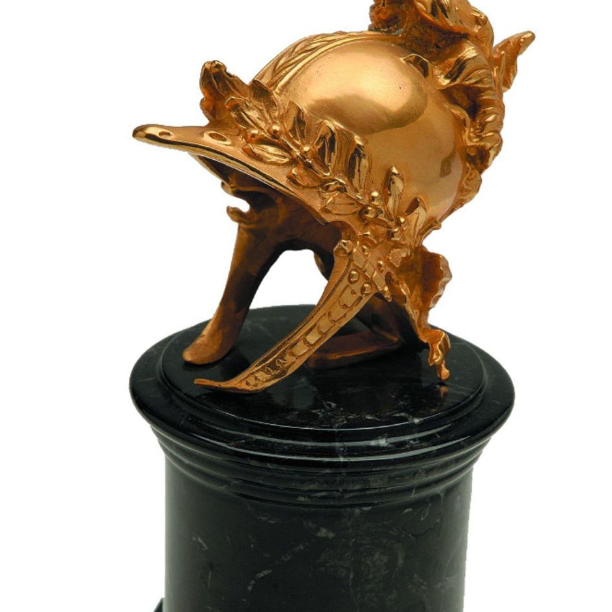 Contemporary Arthur decorative natural brass helm with black marble base For Sale