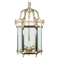 Brass hexagonal hall lantern with bevelled glass panels, in the Georgian style.