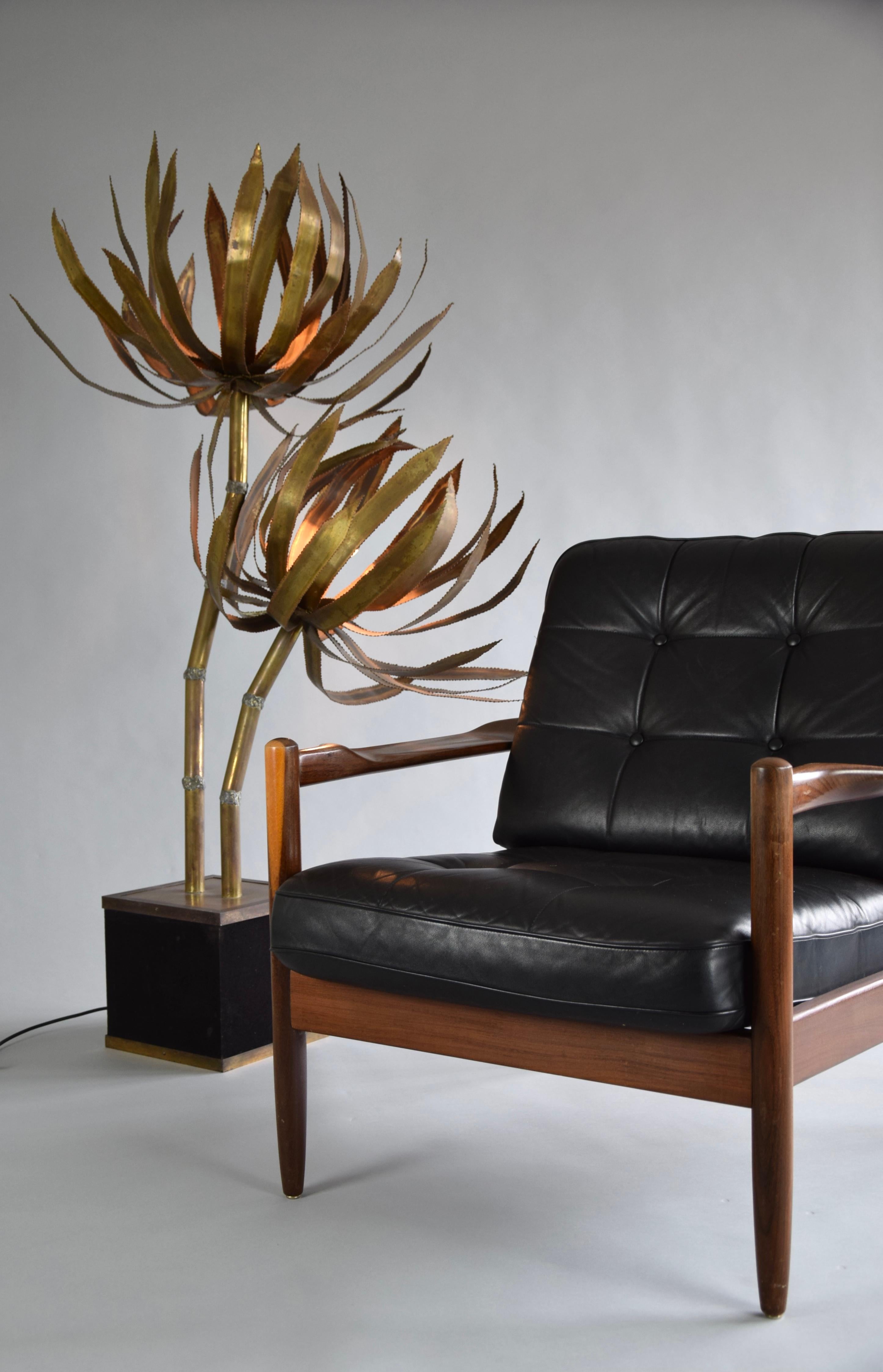 Stylish palm tree floor lamp by Maison Jansen, France, 1970. The floor lamp has a cubic base covered with black velvet upholstery and a brass rim. The palm is made of solid brass and has a nice patina from age. There are a lot of new replica lamps