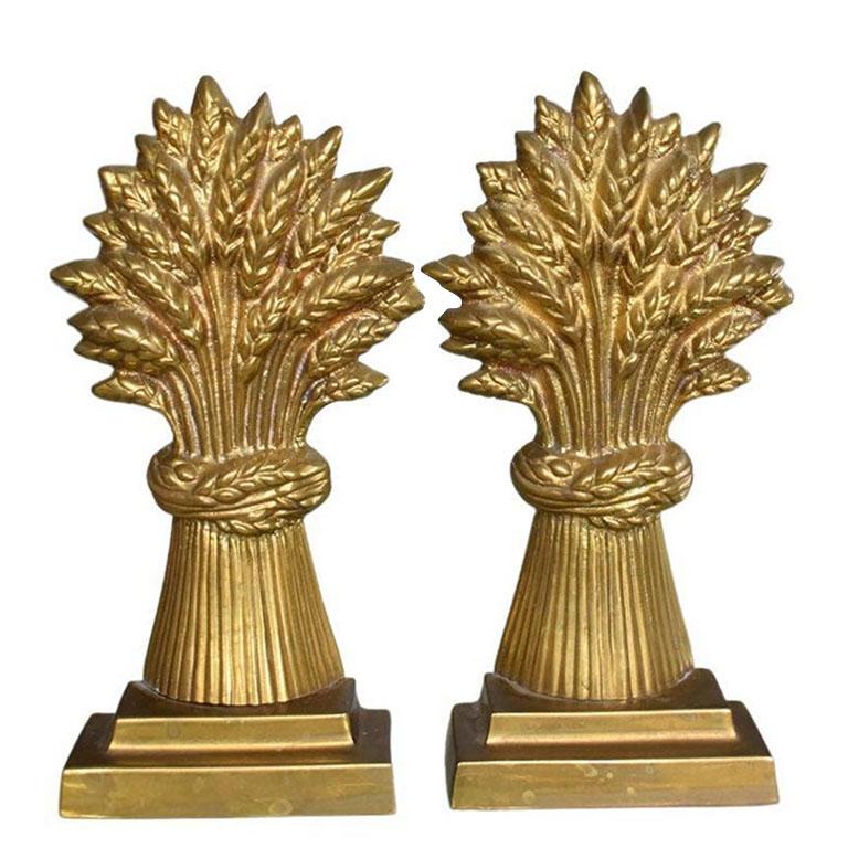 A beautiful Hollywood Regency-style pair of brass sheaf of wheat bookends or door stops. Created from brass, this set will be fabulous on a bookshelf holding up your favorite books. They would also make great door stops, as they are quite heavy. For