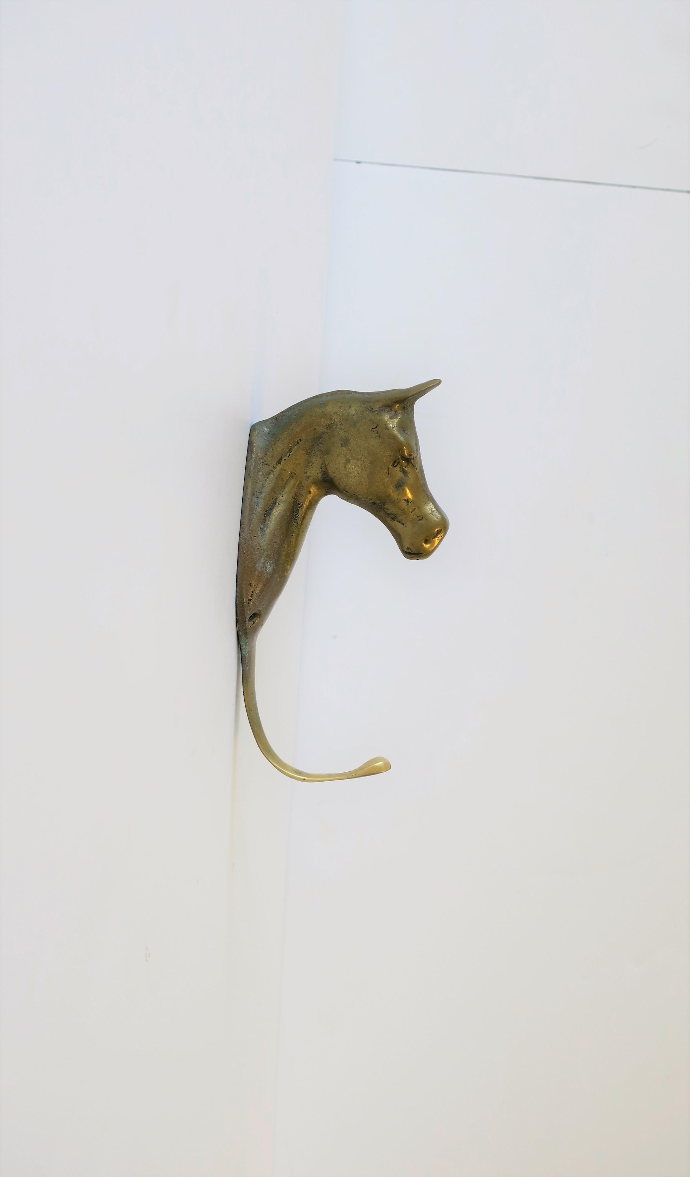 A substantial vintage brass horse or equine hardware wall hook, circa mid-late 20th century, 1960s-1970s. With original screws (in bag), please see image #6. 

Piece measures: 6