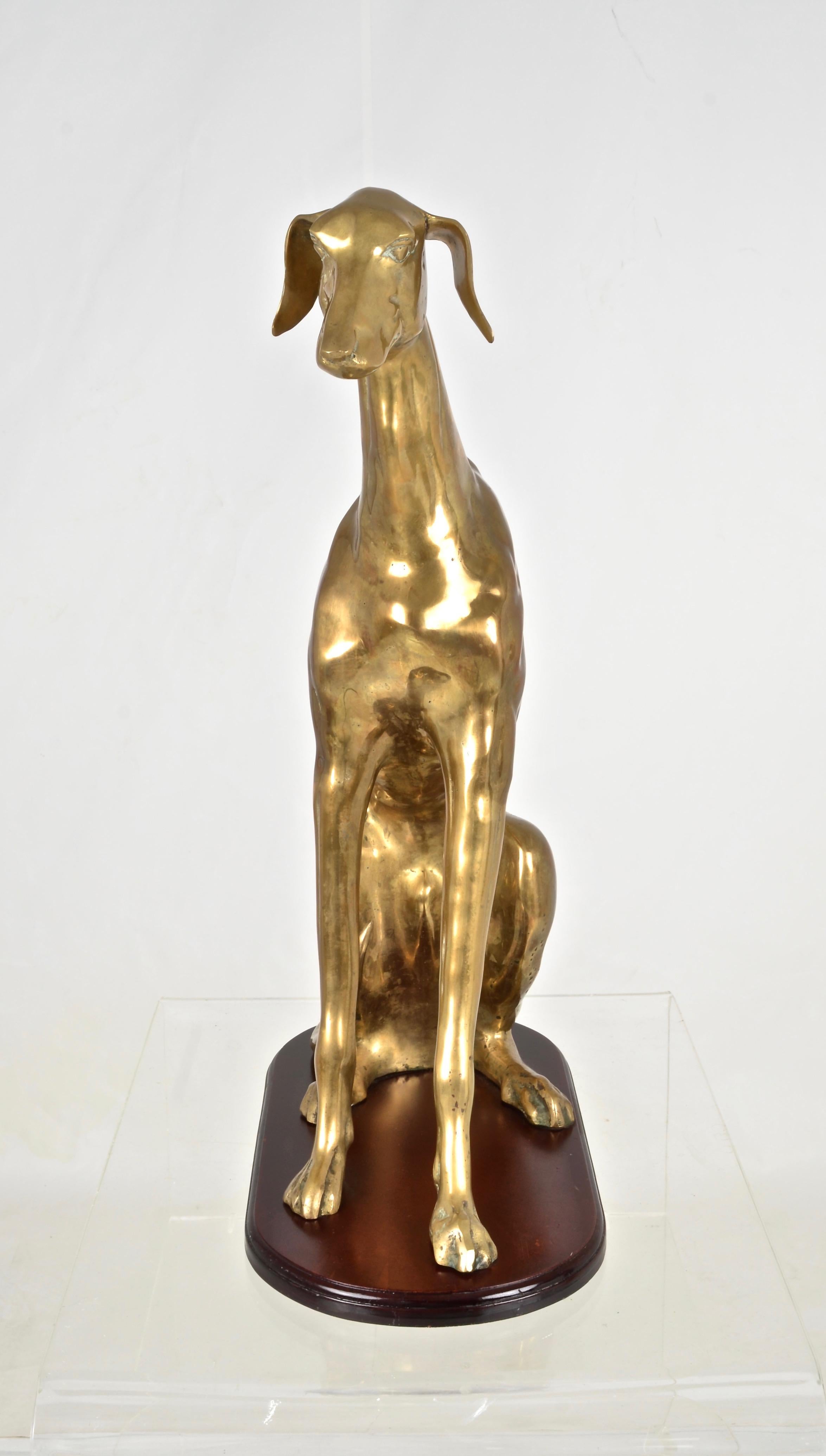 This guy has so much character. We believe he's a whippet. Not starving --just naturally thin (lucky). Wonderful form and attention to detail. The brass dog is mounted on a wood base. Very nice size at 23.5 inch height and 16 inch depth. Brass has