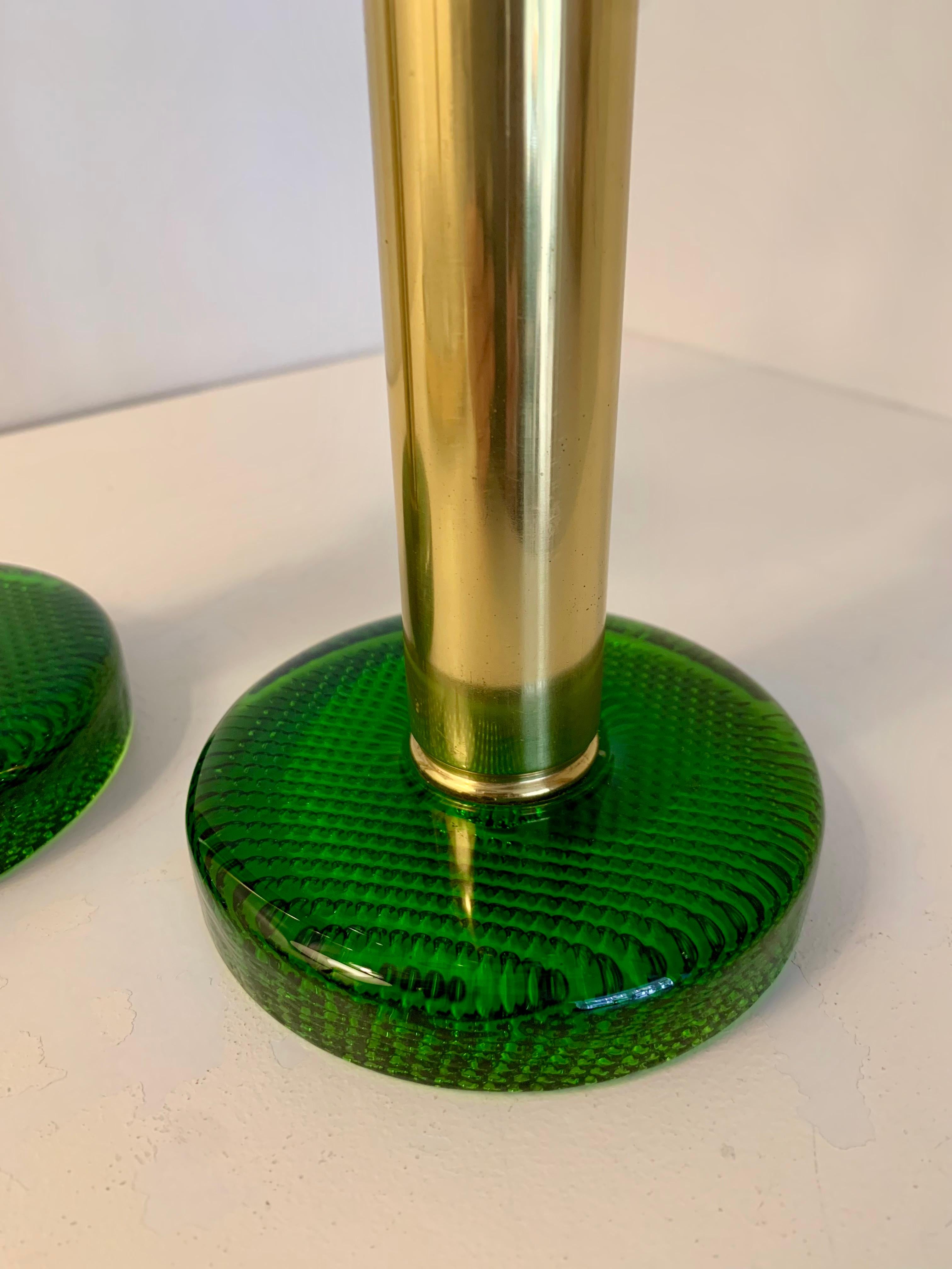 Brass hurricane candle lantern (candle holder) by Swedish designer Hans-Agne Jakobsson with green glass base. 
These candle holders can burn continuously because the brass base interior's are executed with a spring mechanism that pushes the candle