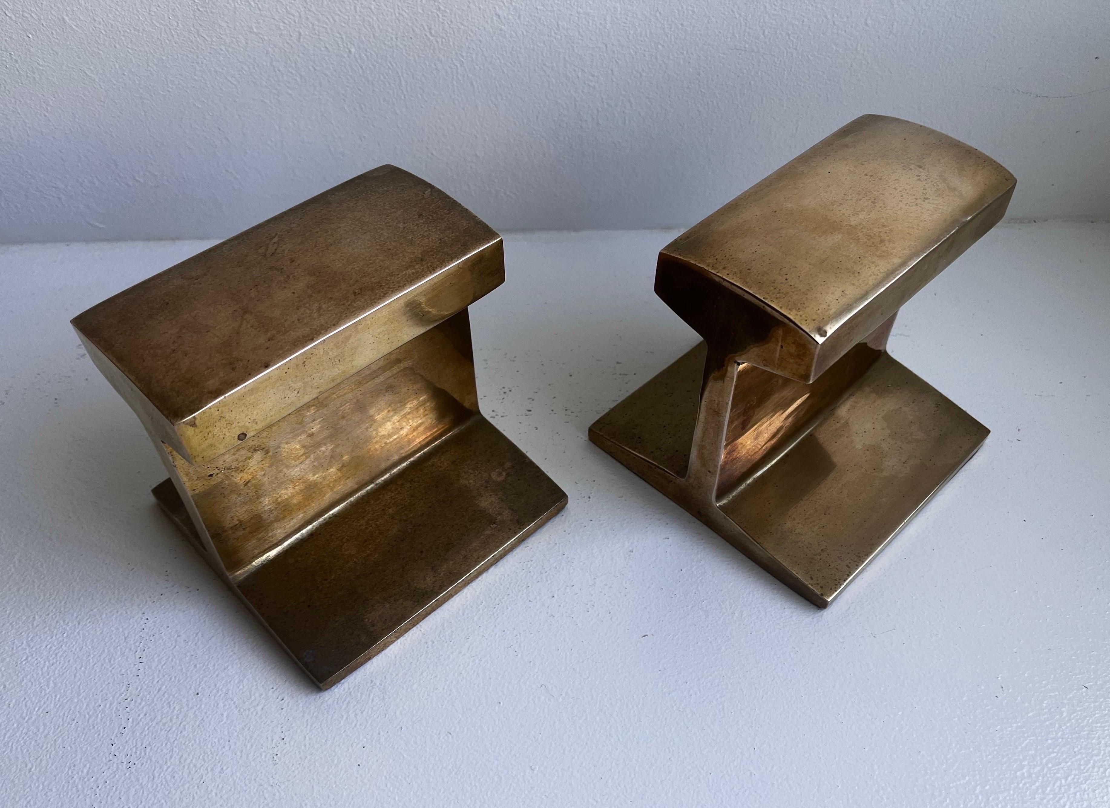 Cast I-Beam Bookends 
in the Style of Ben Seibel

Bohemian / midcentury / Brutalist - circa 1970s

Shape is cast brass with original felt on the bottom
Great patina with some discoloration.