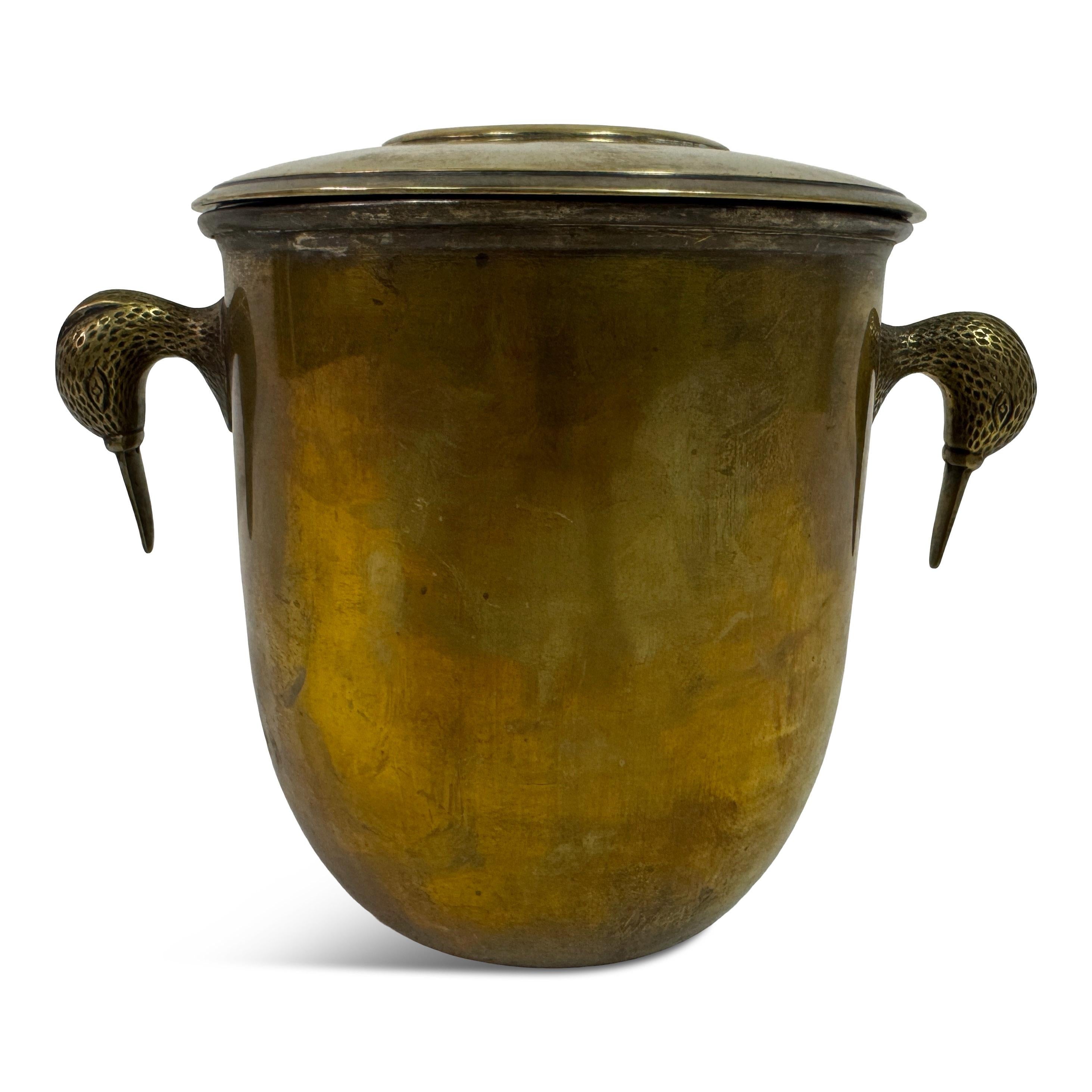 Brass Ice Bucket with Bird-Form Handles, Italy, 1960s


An Italian brass ice bucket of sculptural presence, dating to the 1960s. The rounded body is fitted with a lift-off lid and flanked by two striking bird-form handles, each finely detailed with