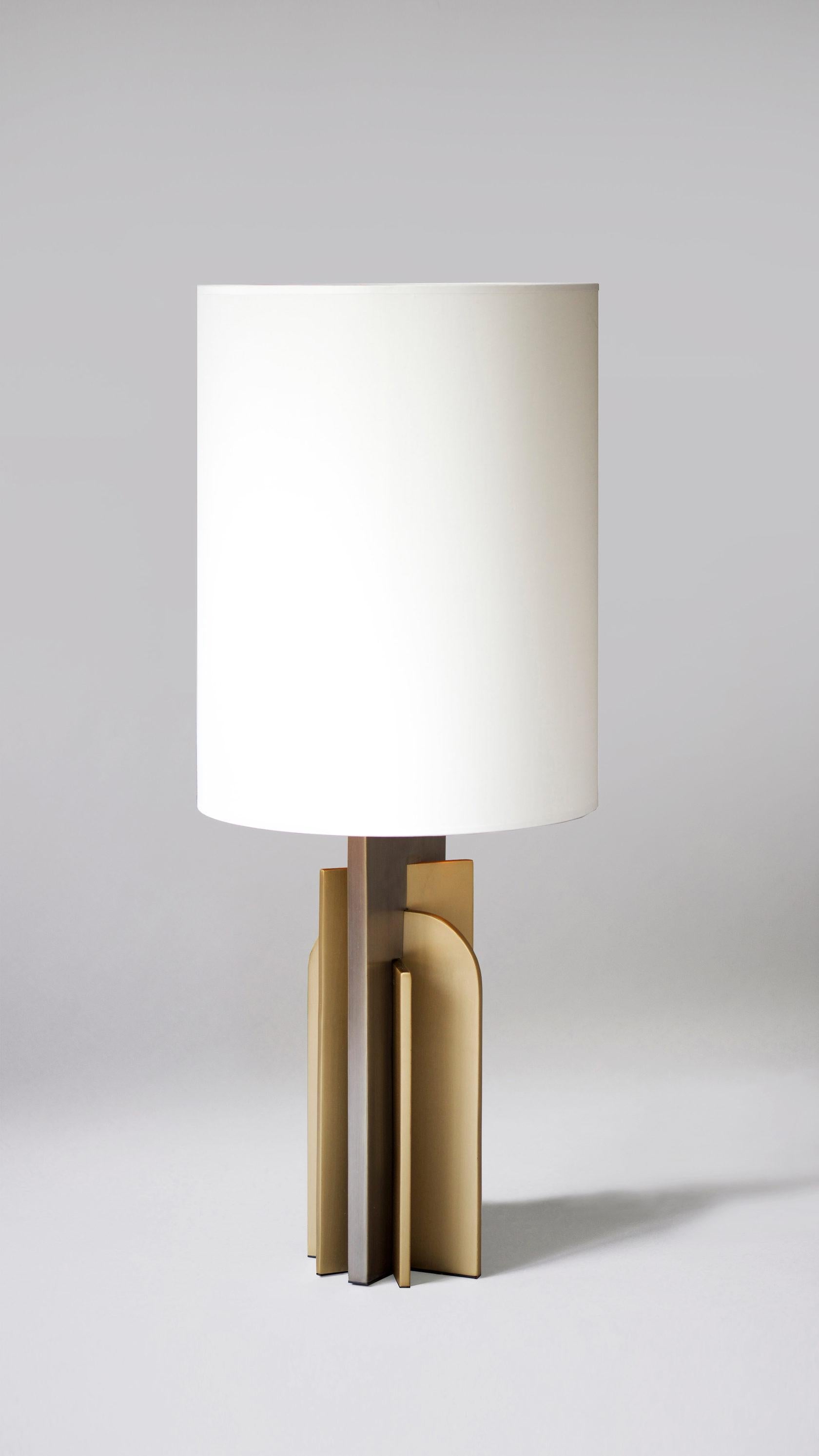Brass Icon Table Lamp by Square in Circle
Dimensions: 17 W x 14 D x 90 H cm
Materials: Brushed brass finish, brushed dark, grey metal, white cotton shade with gold linning 

A modernist oversized table lamp. The base is crafted according to striking