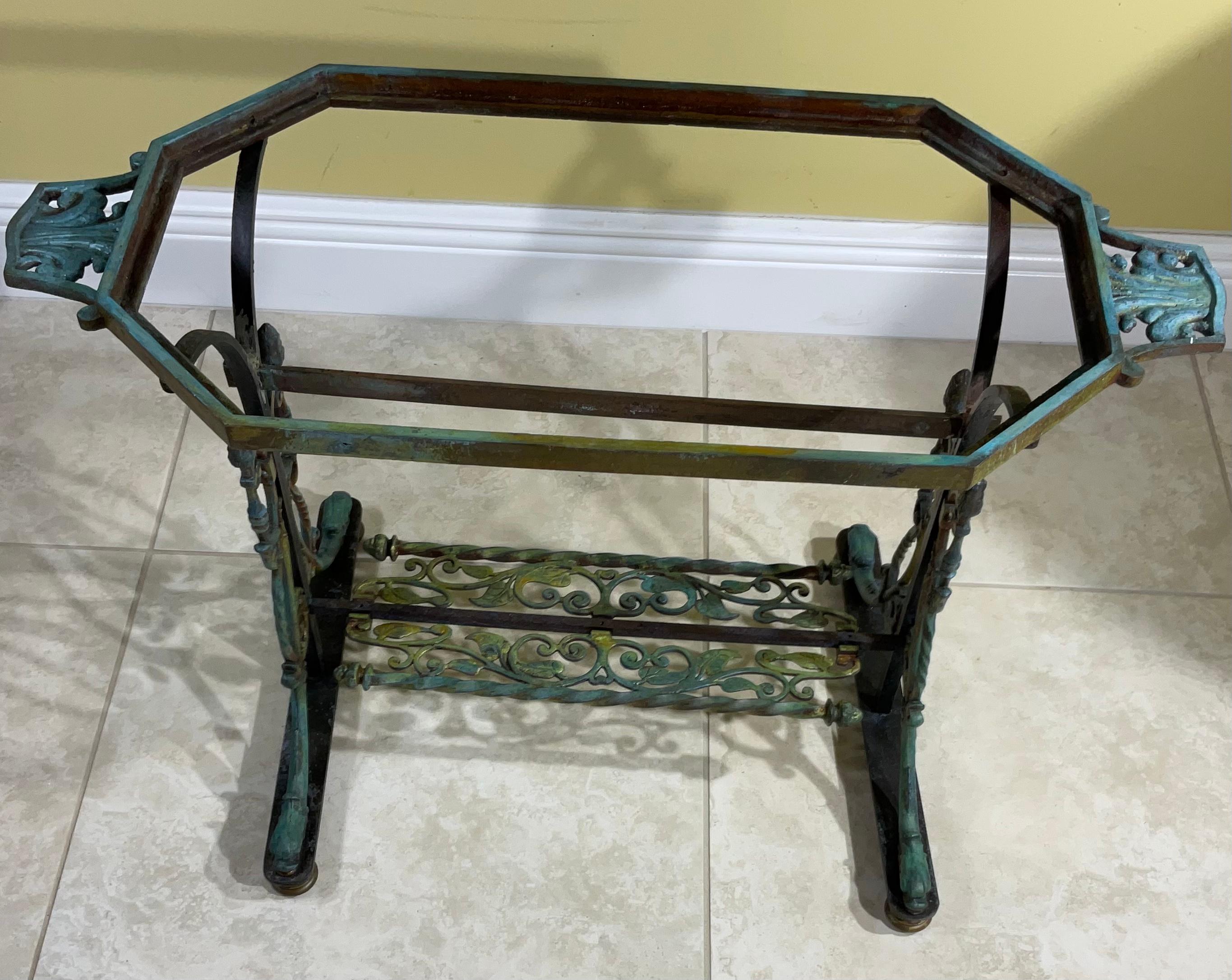 One of a kind table artistically made of combination of hand forged iron and cast brass. Decorative fish like brass feet and detailed top handles, and beautiful 
Green / Cream color onyx top.
Desirable object of art for displaying any