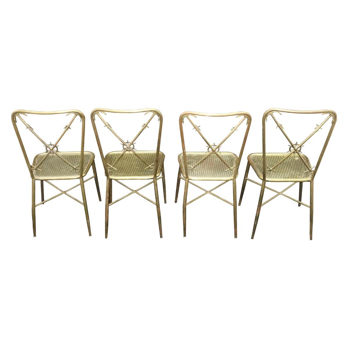 Elegant brass Italian nautical theme side or dining chairs in the manner of Gio Ponti. The backrest has 2 anchor crossbars with a ship wheel motif in the center. The metal seat is reminiscent of the texture used by Mathieu Mategot in his designs.
