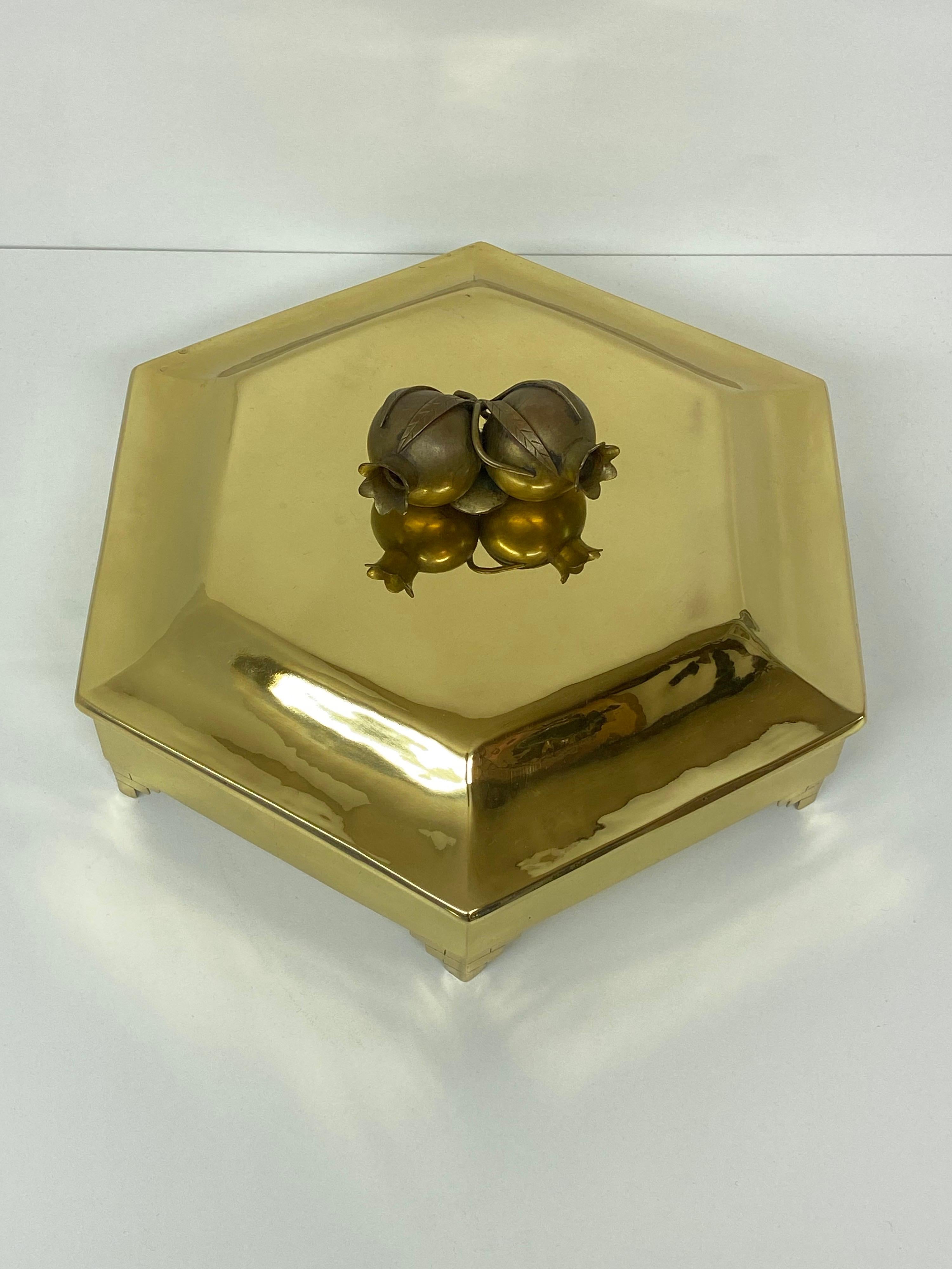 Brass jewelry box with pomegranate motif.
