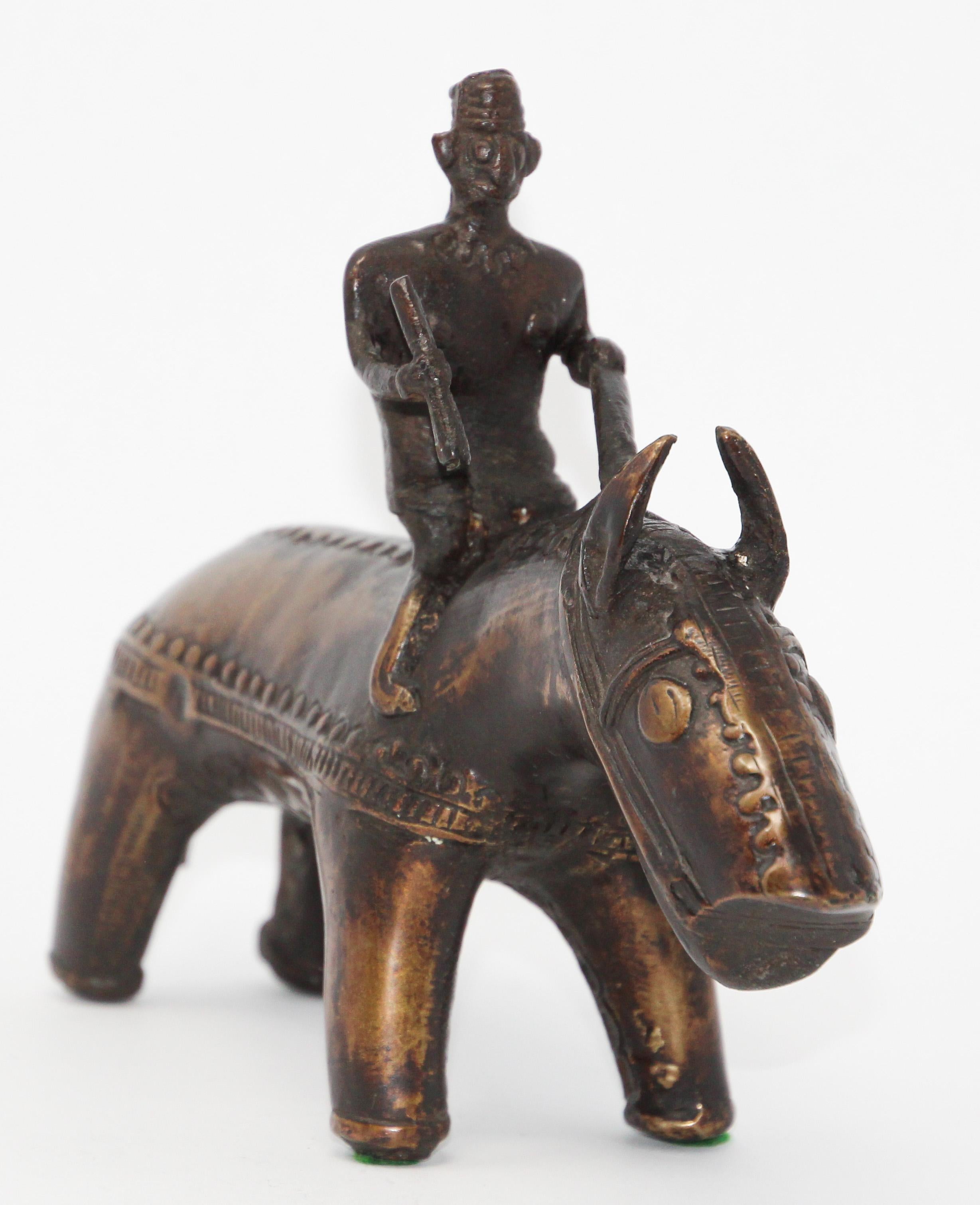bronze statue of woman riding a beast