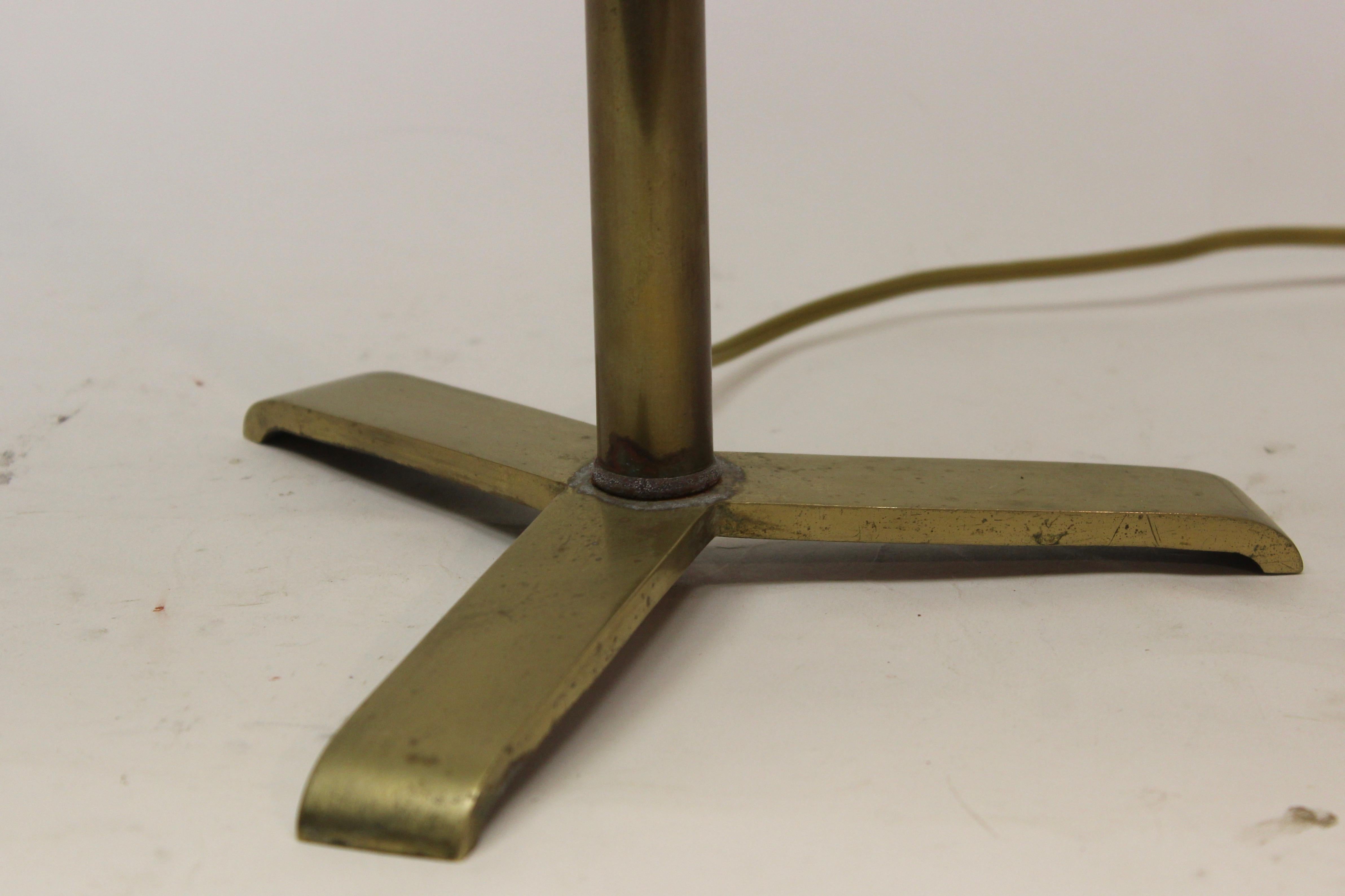 Brass pole lamp on a tripod base with a brass shade.

Measures: Base: 26