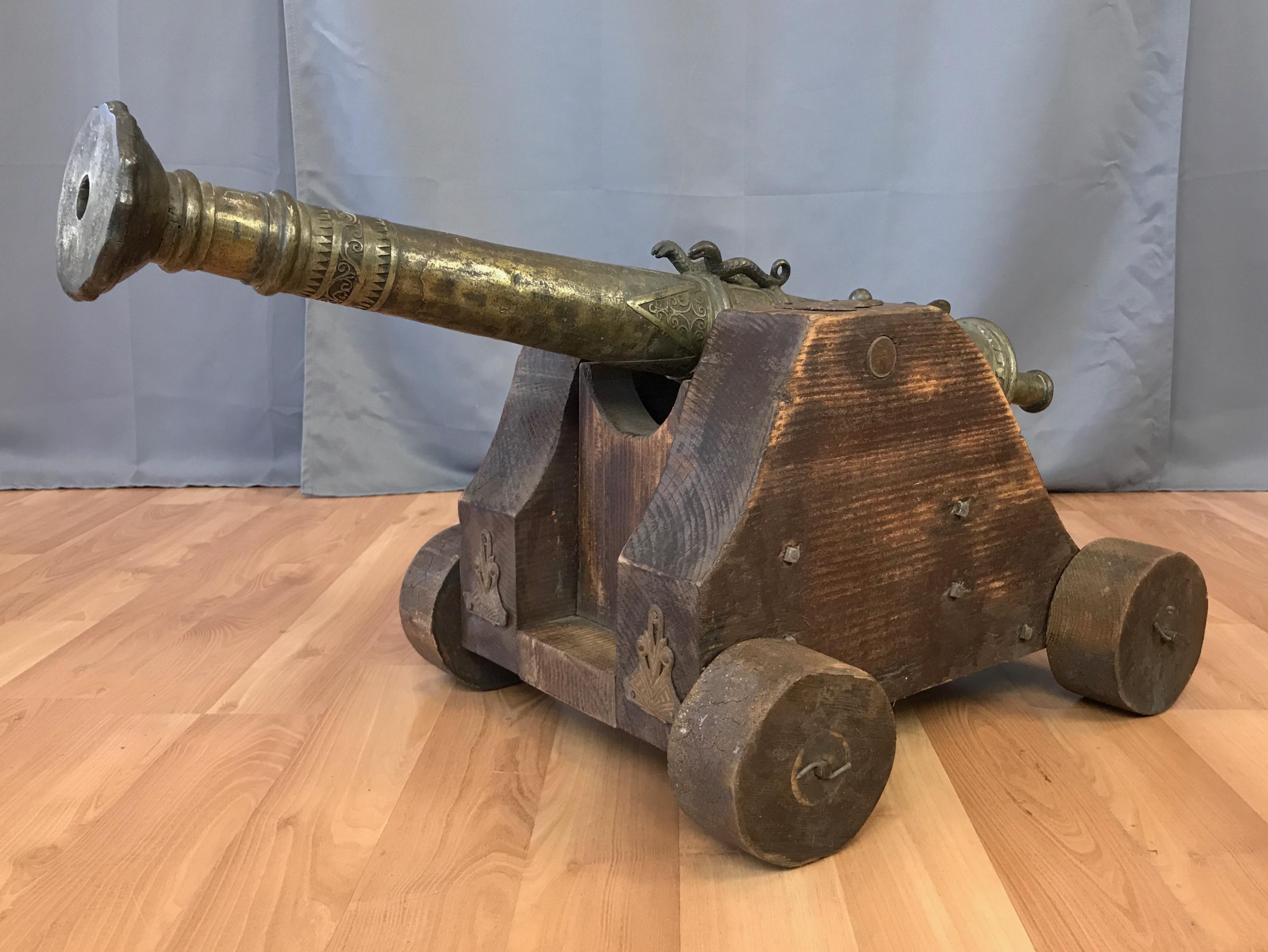 A circa 1900 cast brass lantaka cannon from maritime South East Asia, presented on a more recent custom made wood display carriage.

Used primarily for defense, lantaka (or rentaka) were a type of brass or bronze swivel gun found on warships and