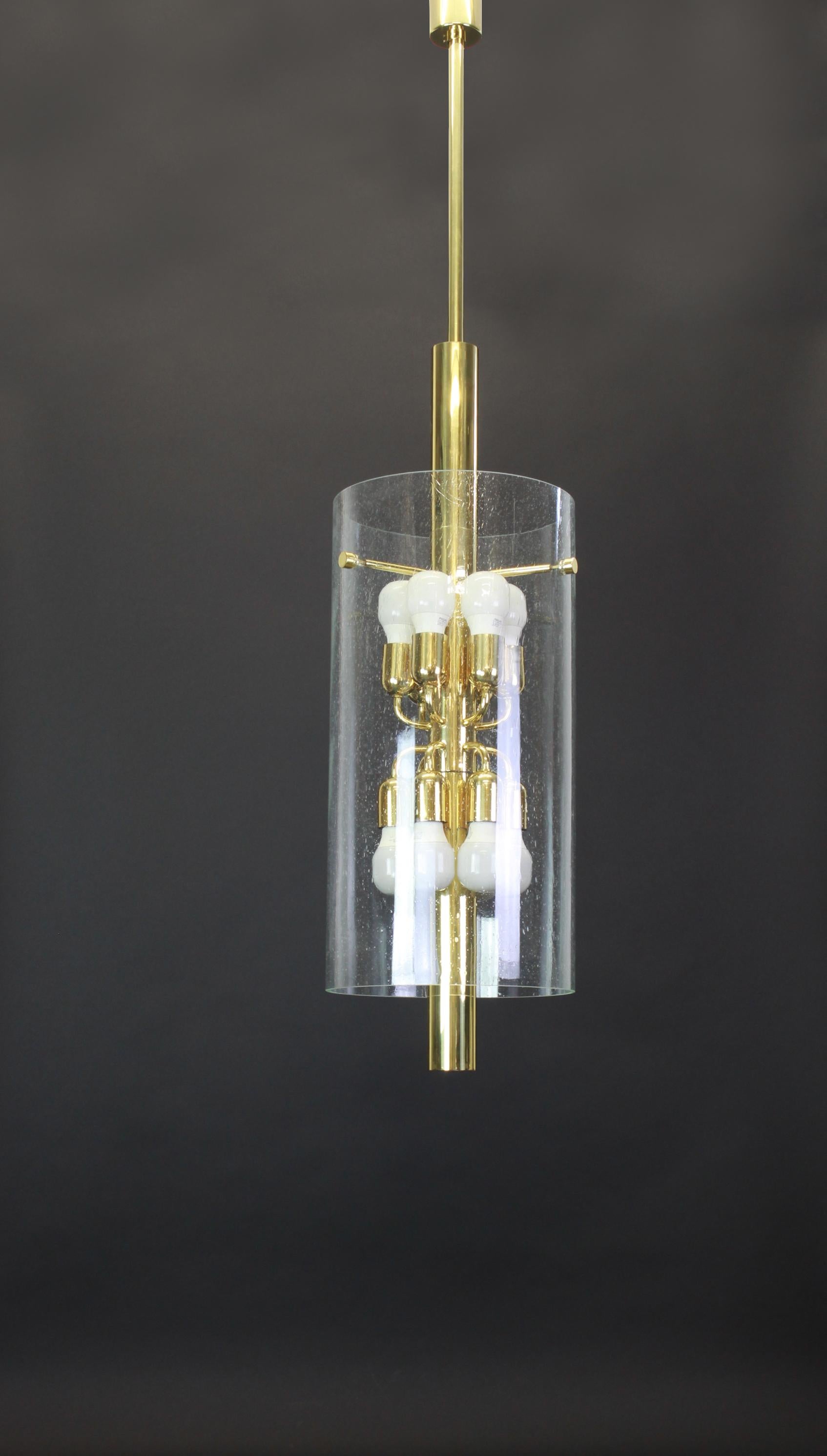 Brass pendant fixture with cylindrical glass shade featuring inclusive glass bubble design by Limburg, Germany, 1960s

Heavy quality and in very good condition. Cleaned, well-wired and ready to use. The fixture requires 12 x E27 Standard bulbs